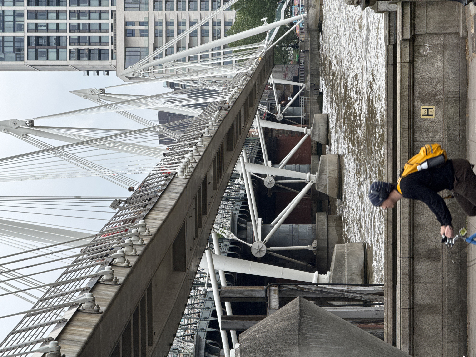 Tourist documents London landmarks walk near Thames bridges
