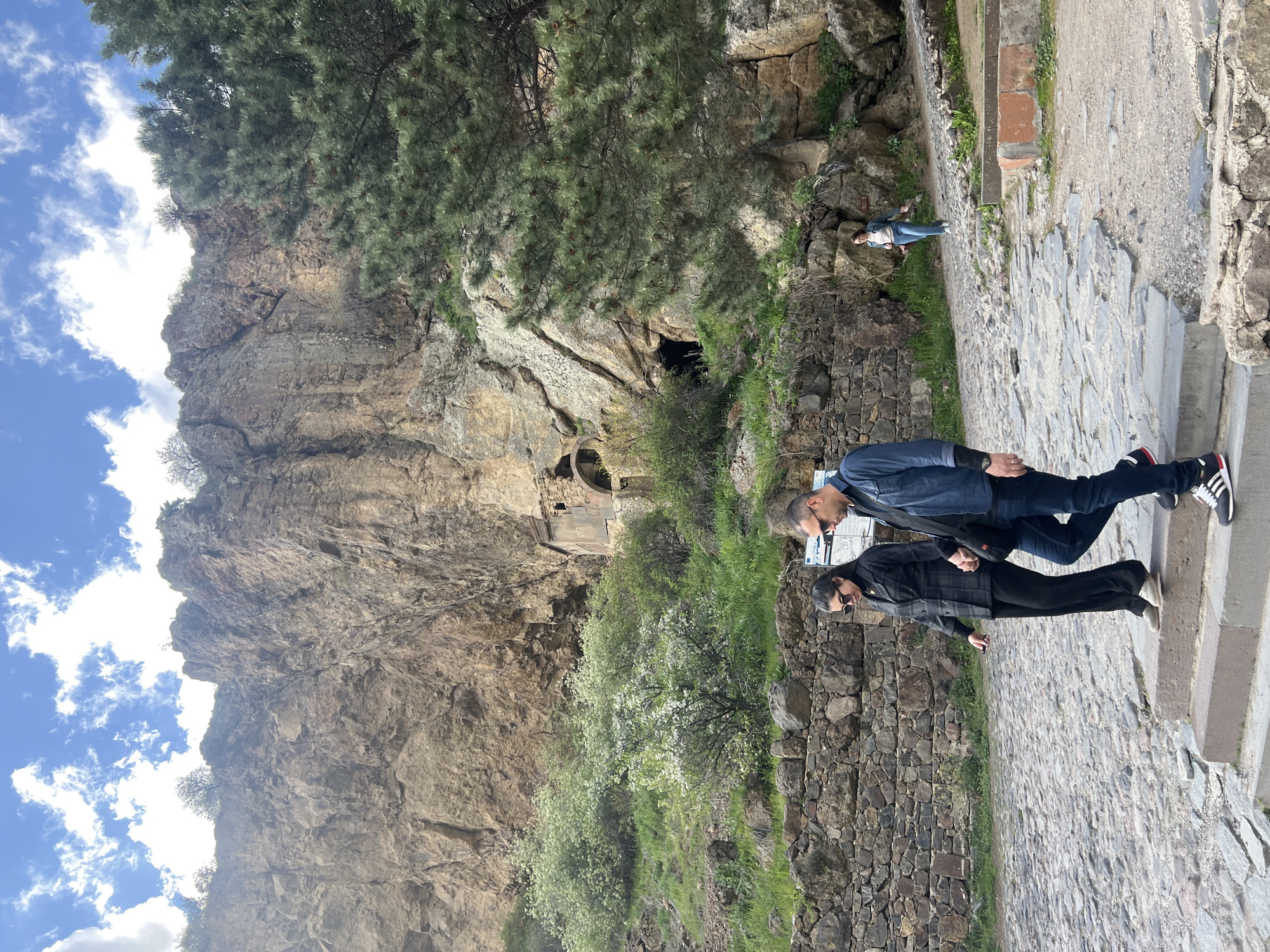 Tourists explore historic Geghard Monastery complex in Armenia