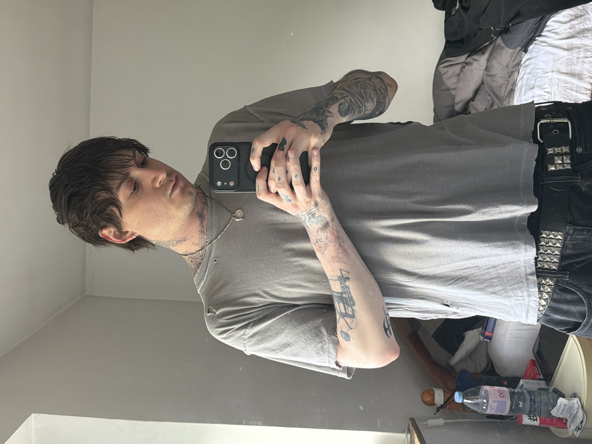 Young man takes mirror selfie in London room