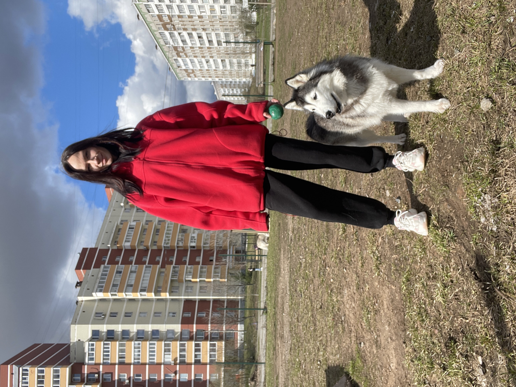 Woman plays with husky dog in Izhevsk park