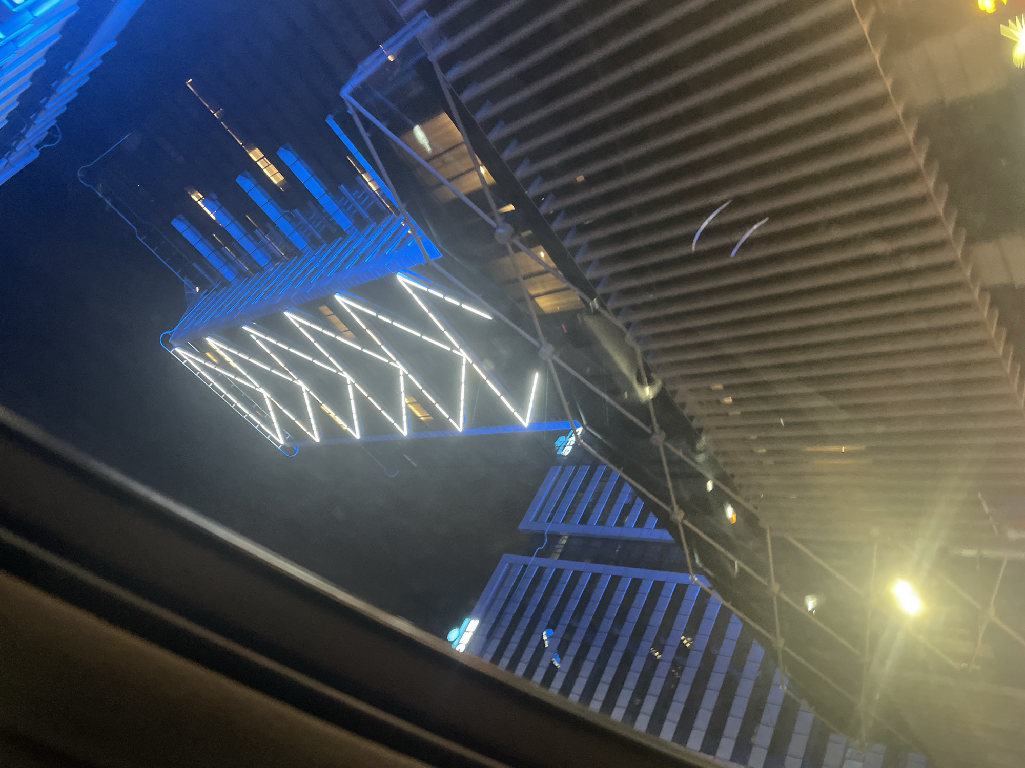 Night drive captures modern Sofia building reflection on windshield
