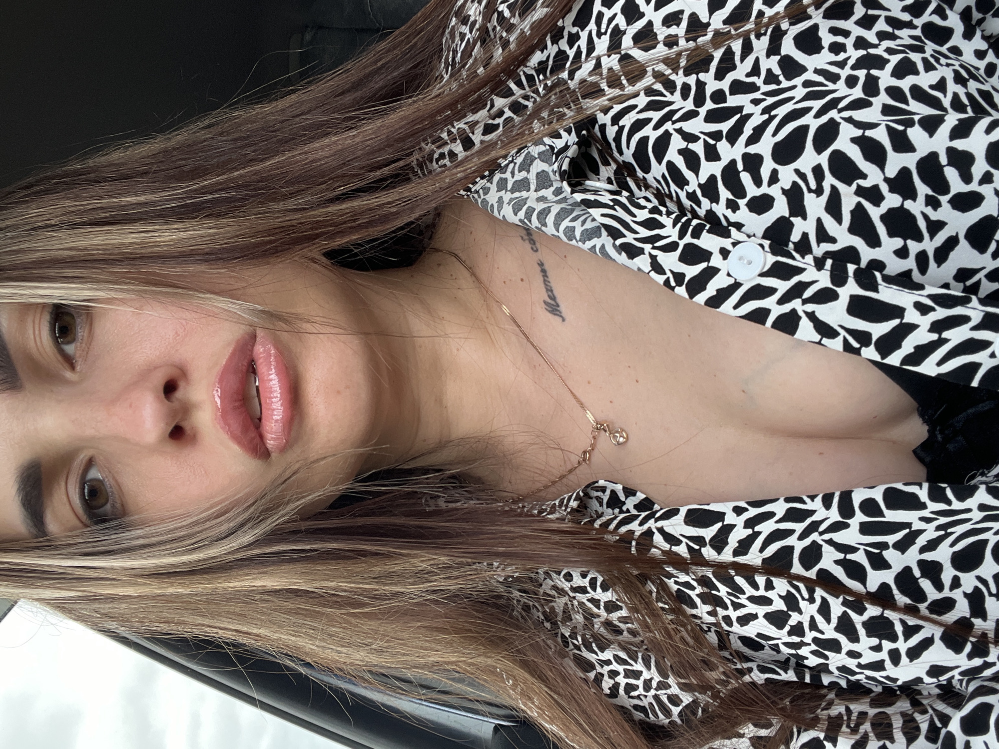 Woman takes selfies during car journey in rural area