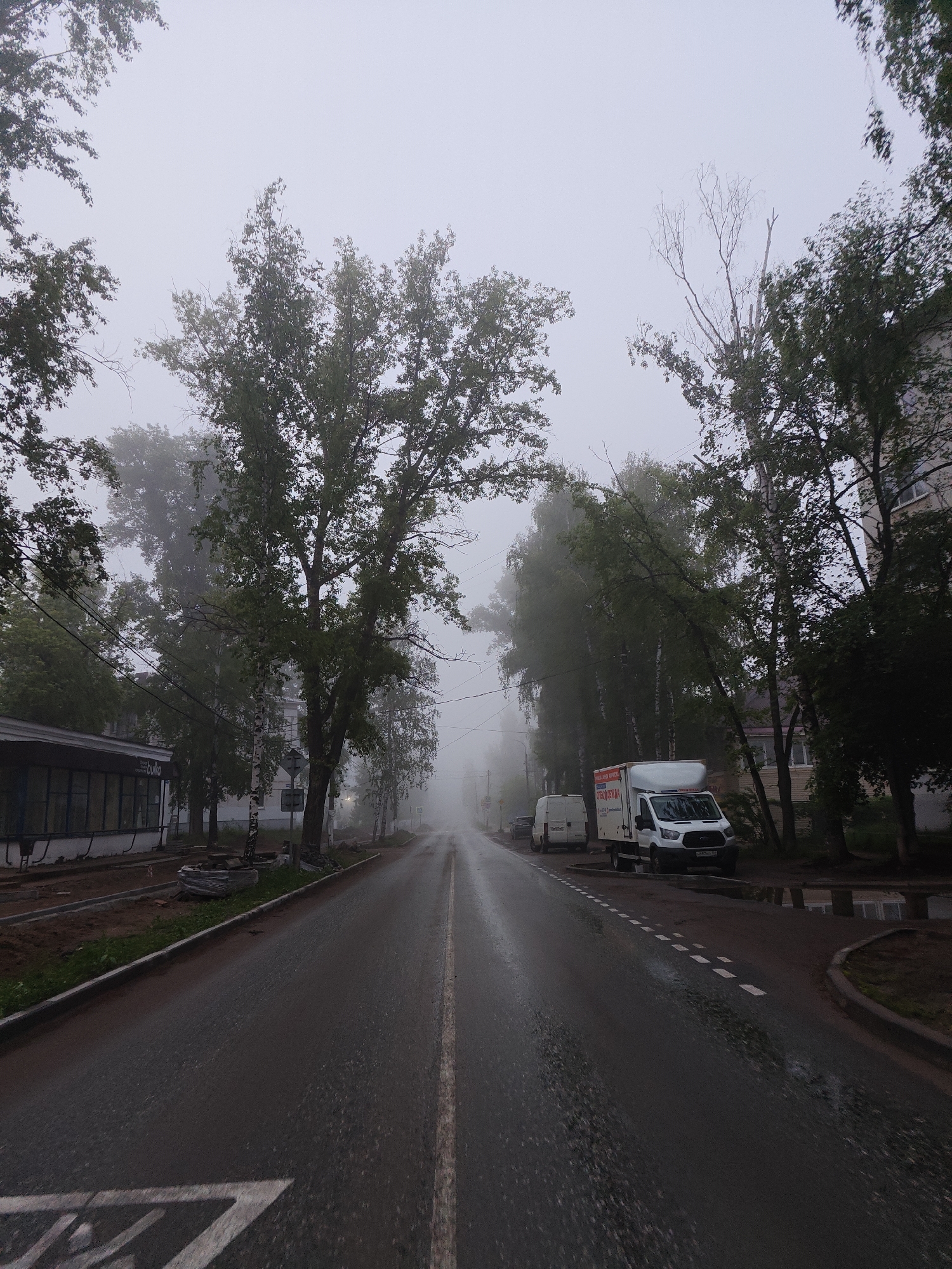 Heavy fog shrouds quiet streets in Chaikovsky, Russia