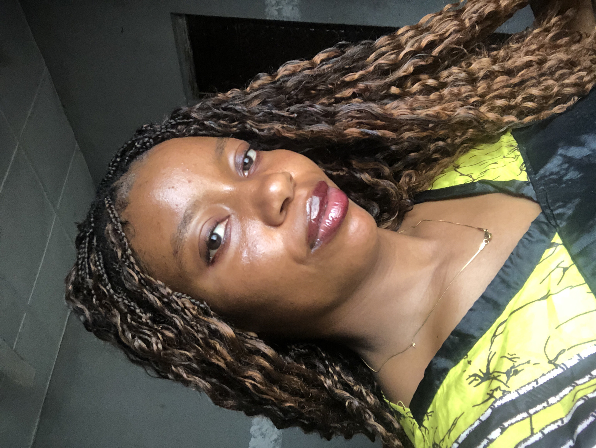 Woman takes selfies indoors in Nigeria during morning photo session