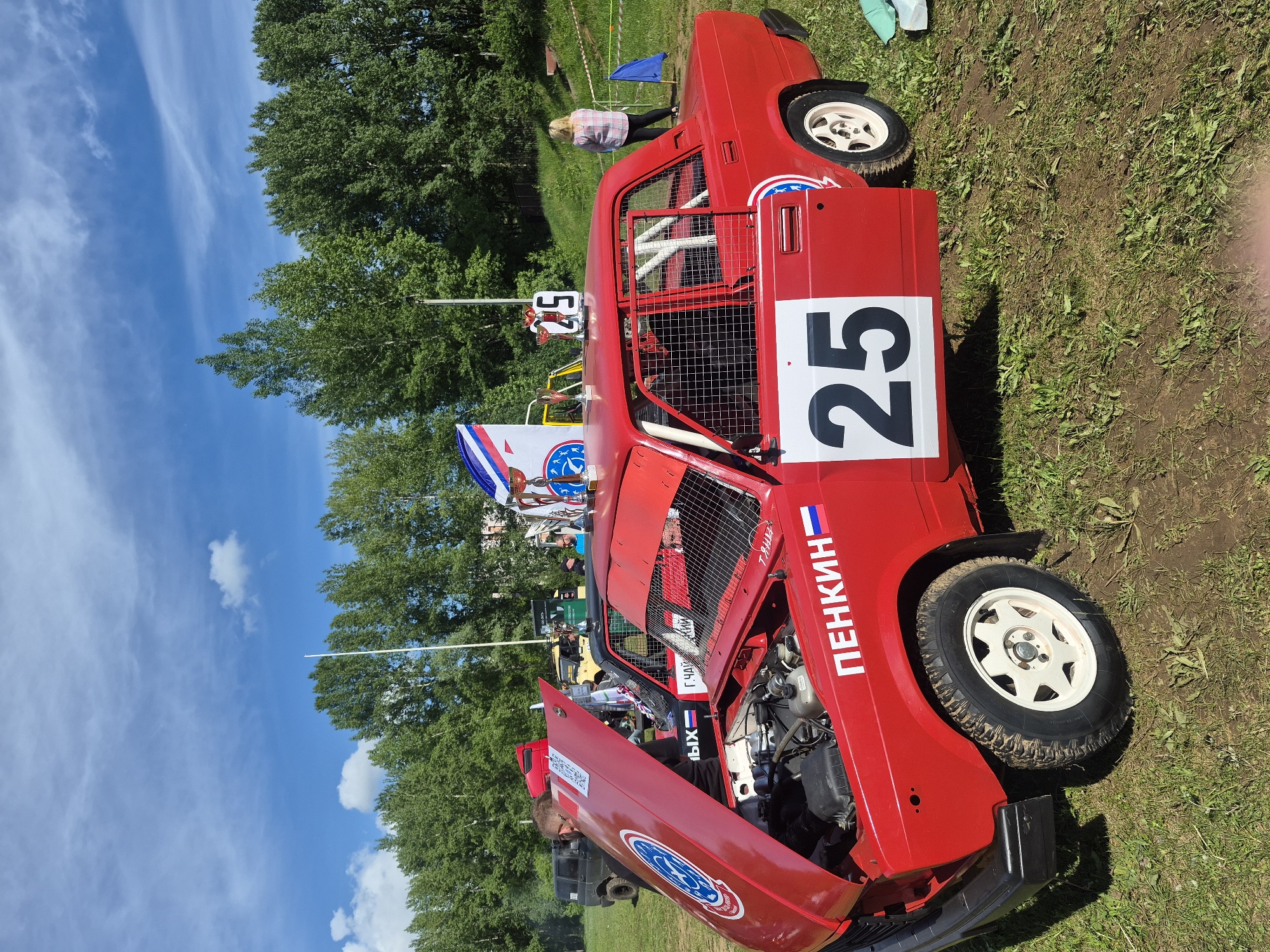 Mixed urban scenes: race car maintenance, military monument, social graphic