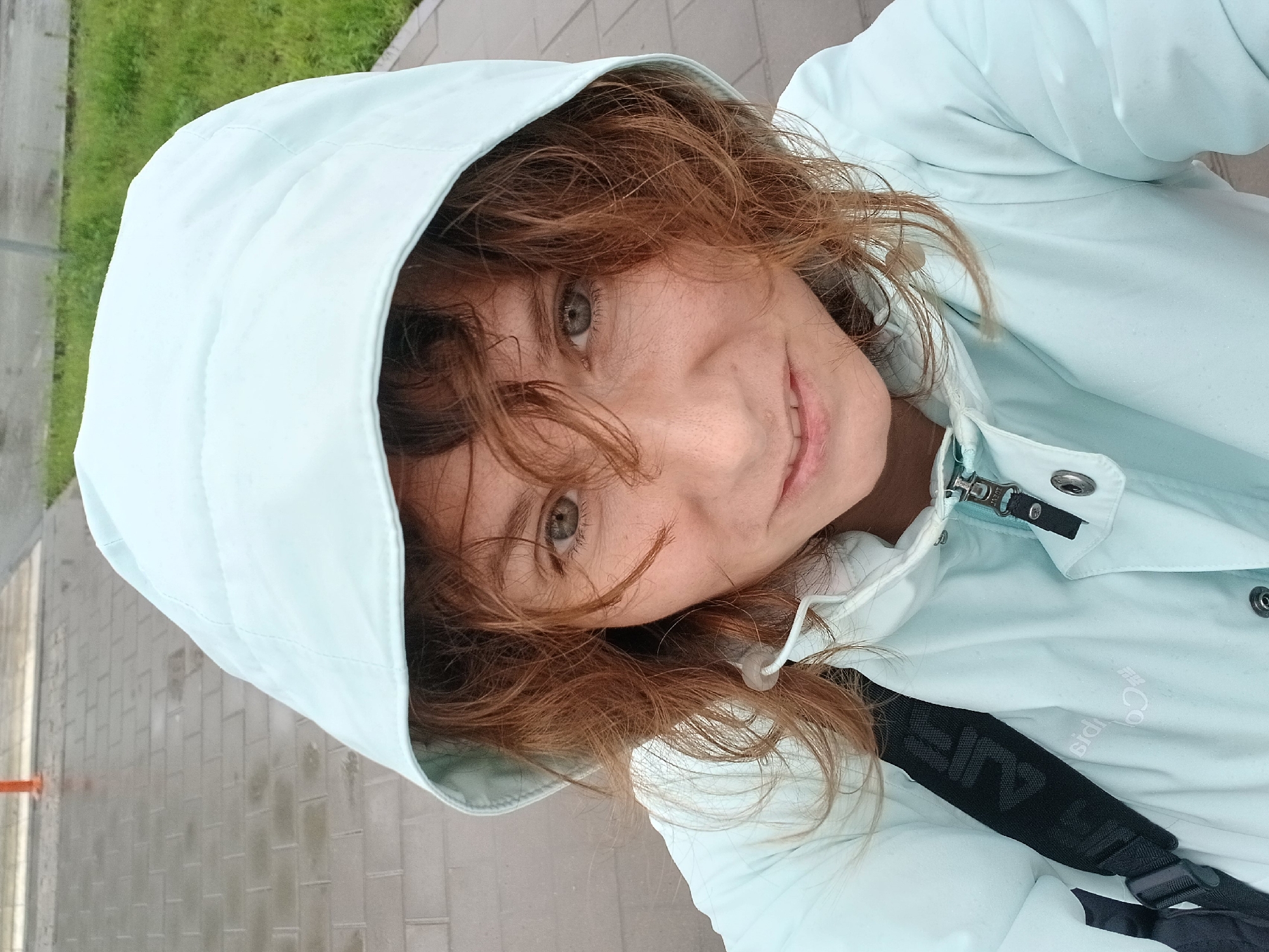 Woman and child share umbrella during rainy day in Yekaterinburg
