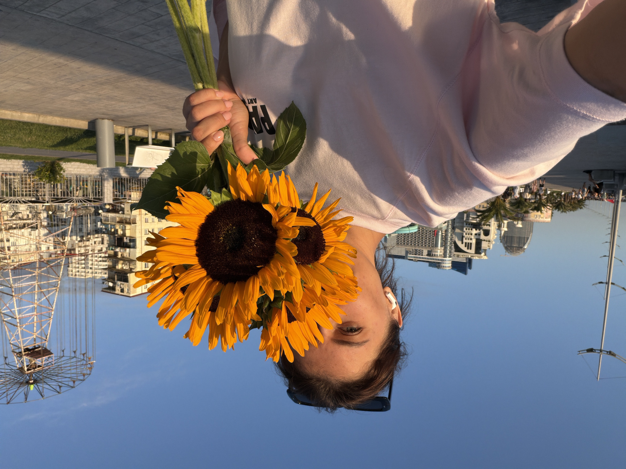 Sunflower bouquet photoshoot along Batumi's waterfront promenade