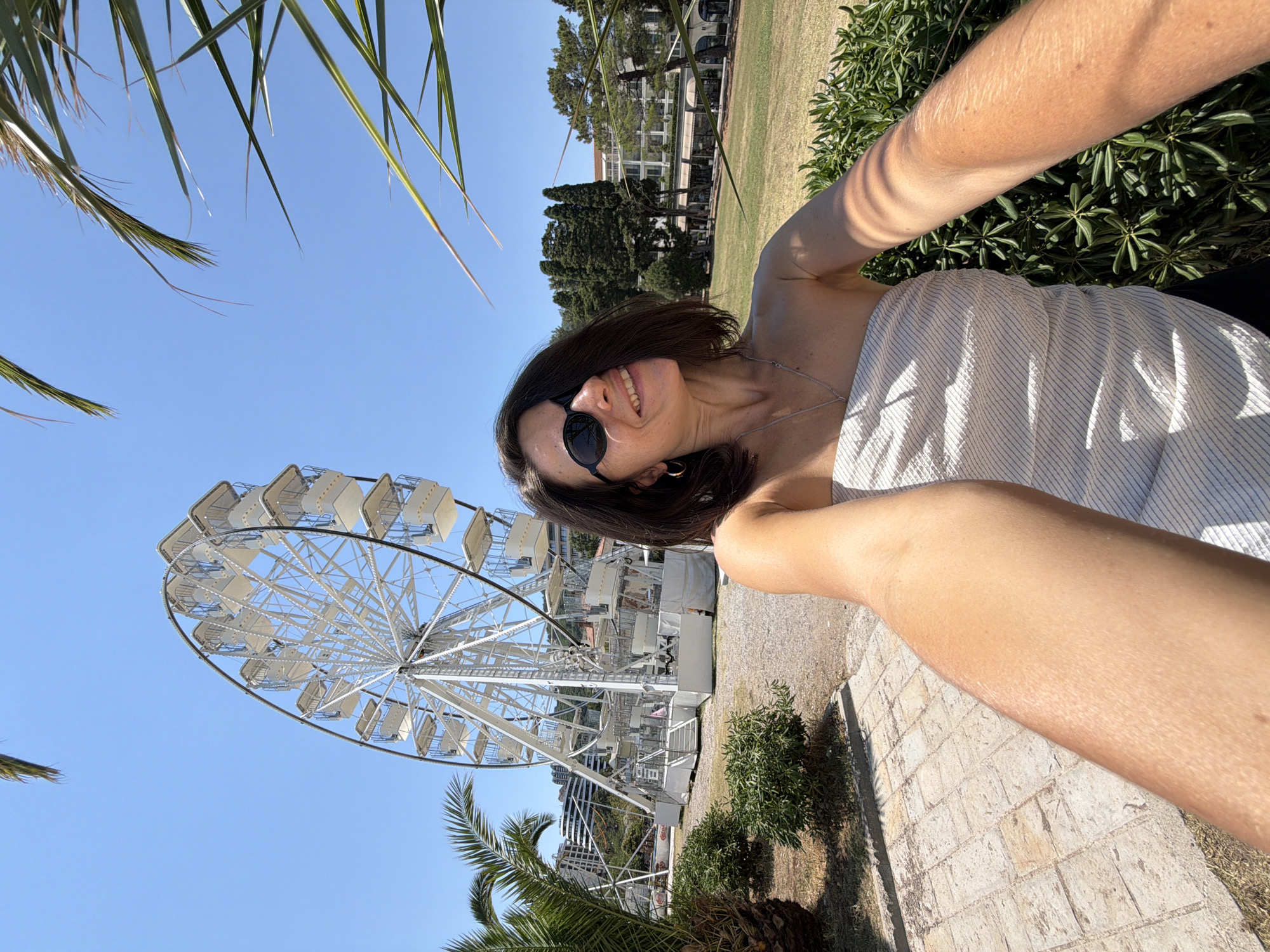 Sunny day out: Ferris wheel, waterfront, and boats