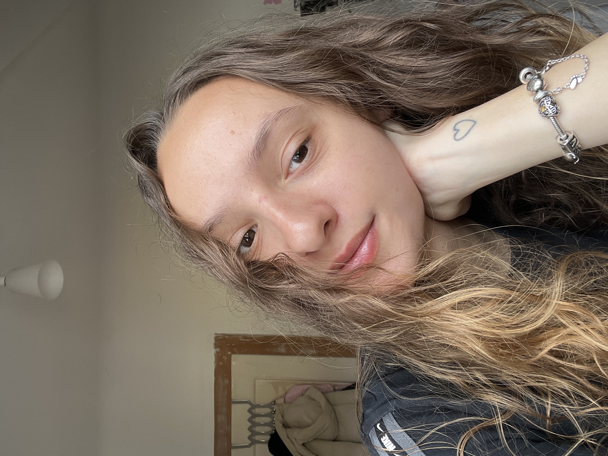 Young woman takes selfie in Saarbrücken showing heart tattoo