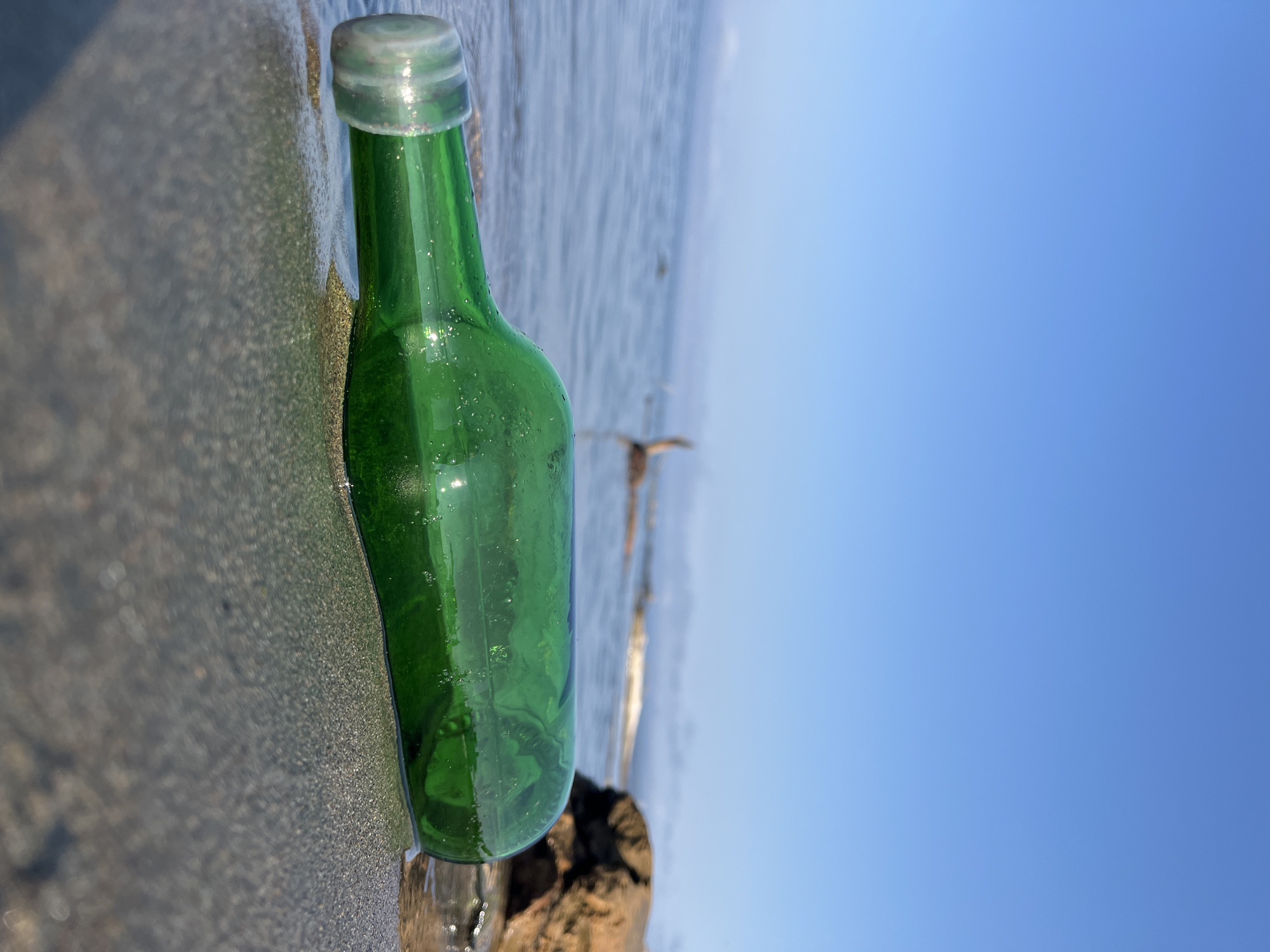 Beach scene on a Russian riverbank, bottle and runner