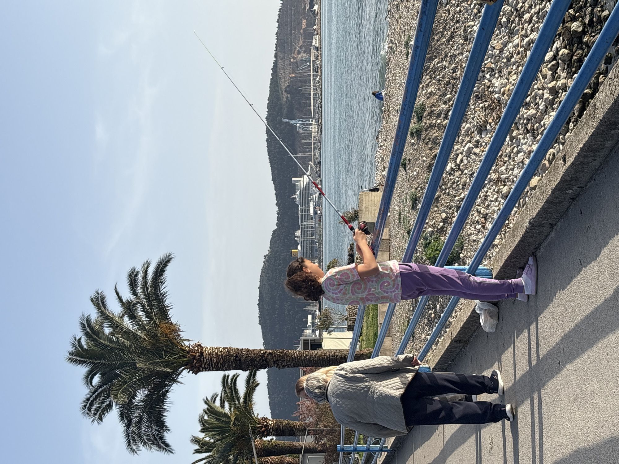 Child fishes from pier in Bar, Montenegro coastal area