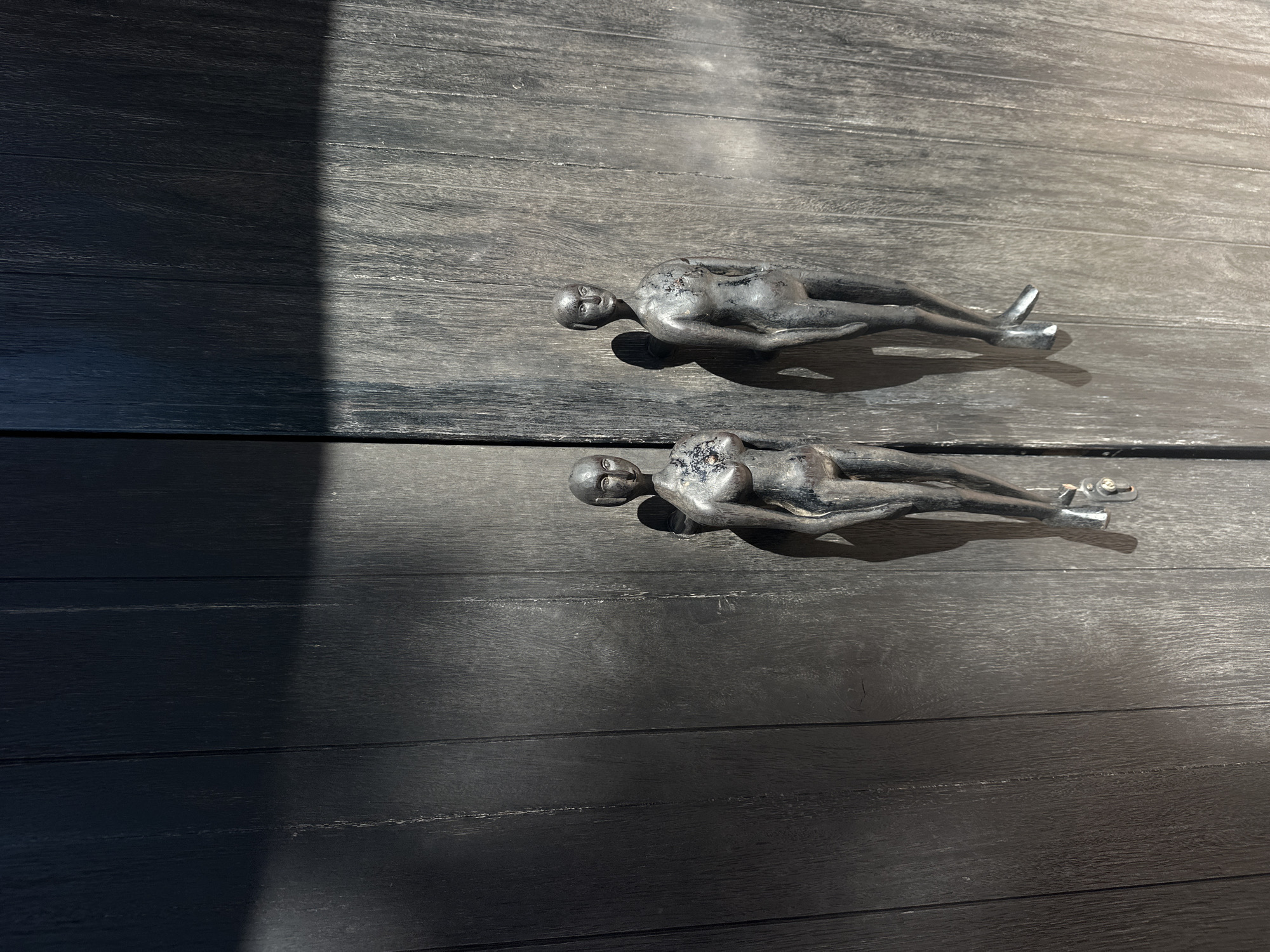 Metal figurines spotted on wooden surface in Pecatu