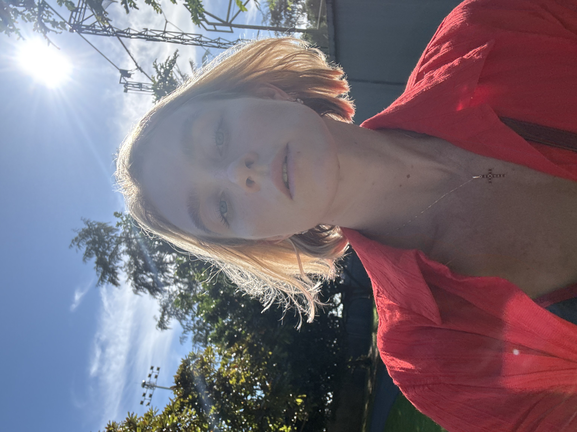 Woman photographed at Karon beach amid palm trees, clear skies