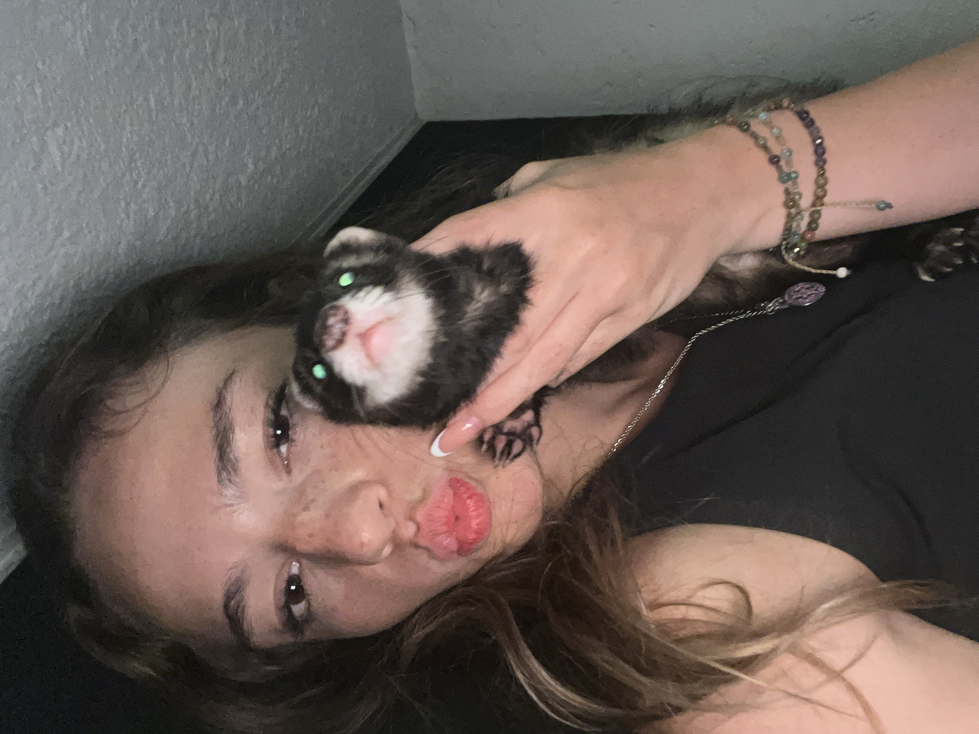 Woman poses with pet ferret in Tlaxcalancingo, Mexico
