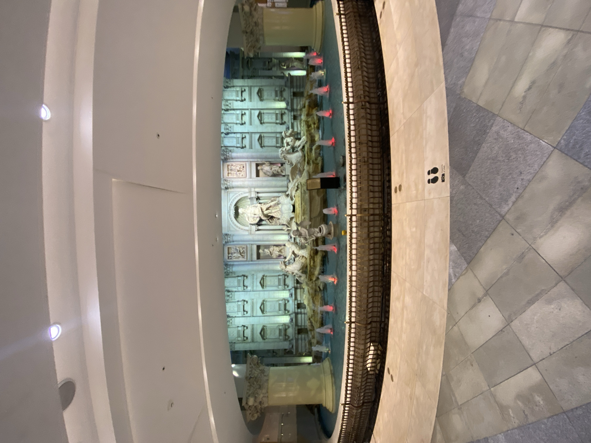 Visitor approaches illuminated Trevi Fountain replica at Seoul COEX Mall