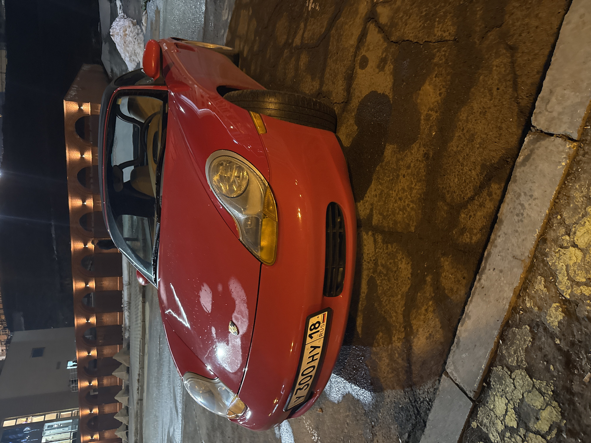 Red Porsche spotted on wet Izhevsk street
