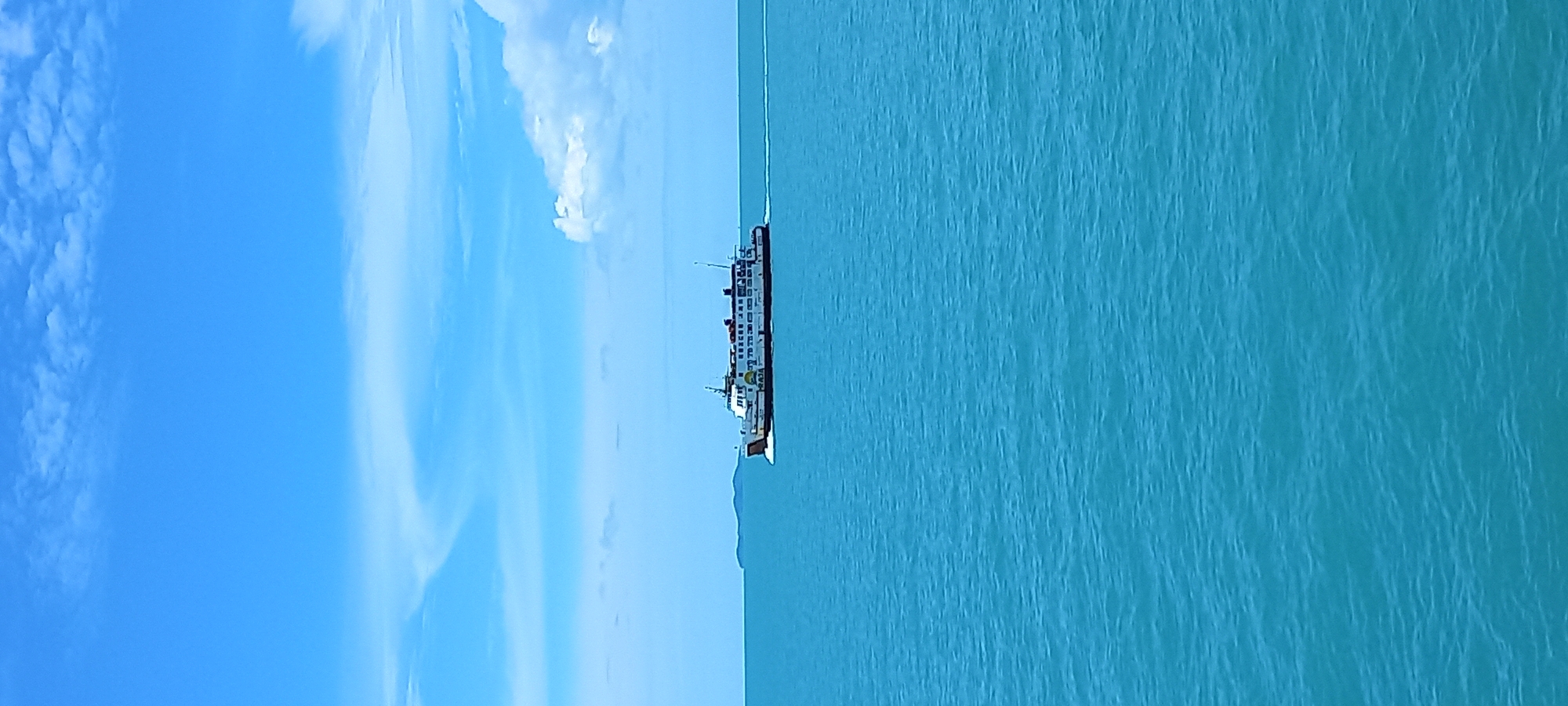 Ferry crosses Thai waters under clear morning skies