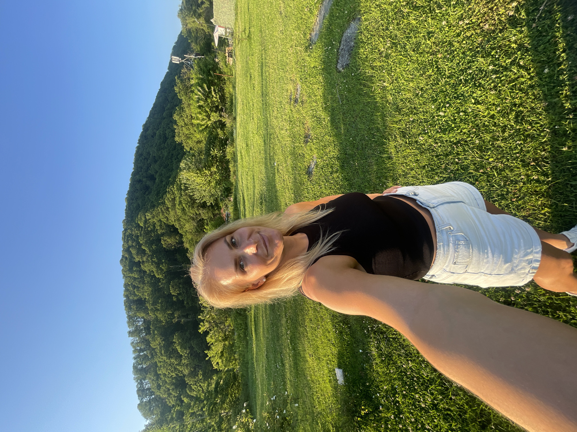 Woman photographs herself at scenic Russian coastal locations