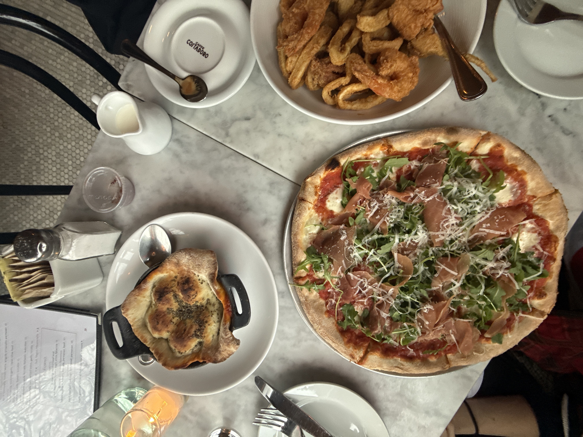 NYC restaurant dinner featuring arugula prosciutto pizza documented