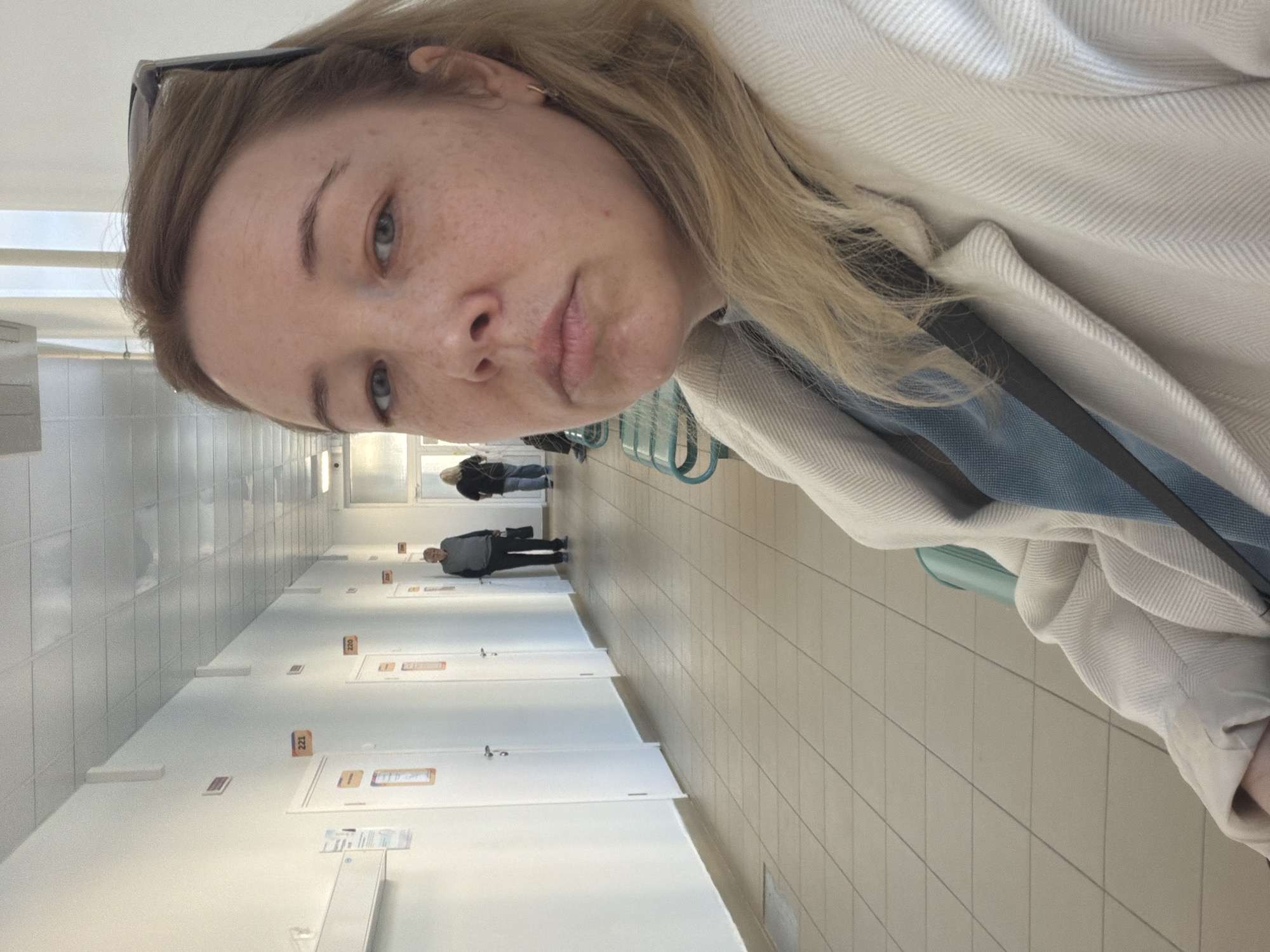 Woman takes selfies in Russian apartment building hallway