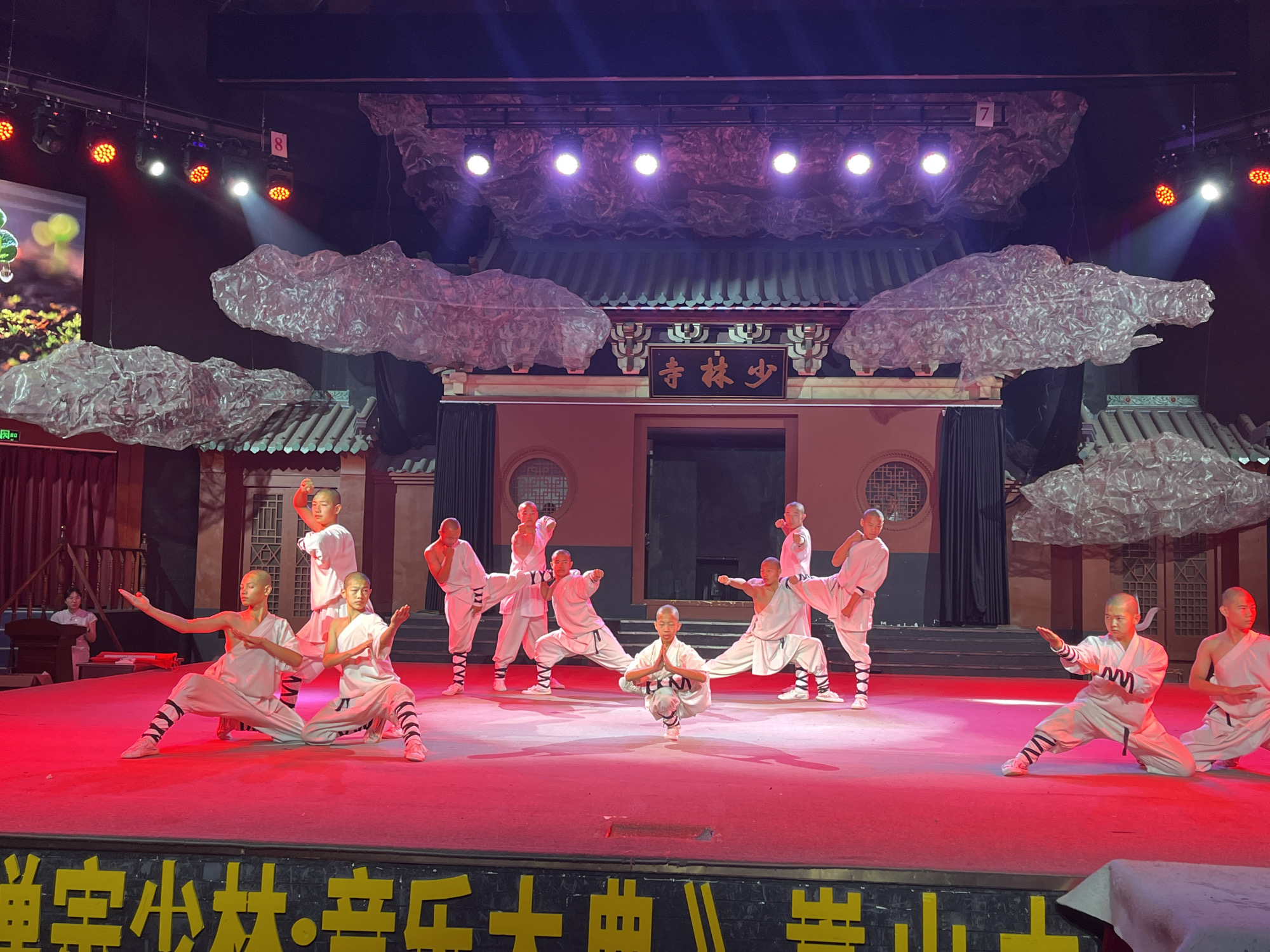 Shaolin martial arts troupe performs on stage and temple grounds