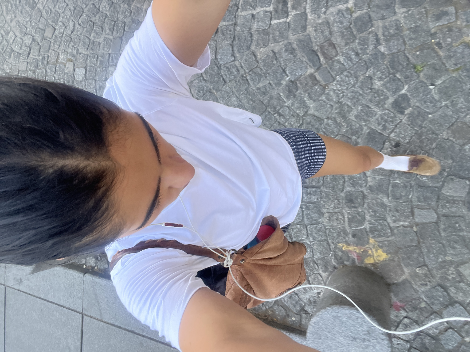 Woman takes selfies near Centre Pompidou in Paris