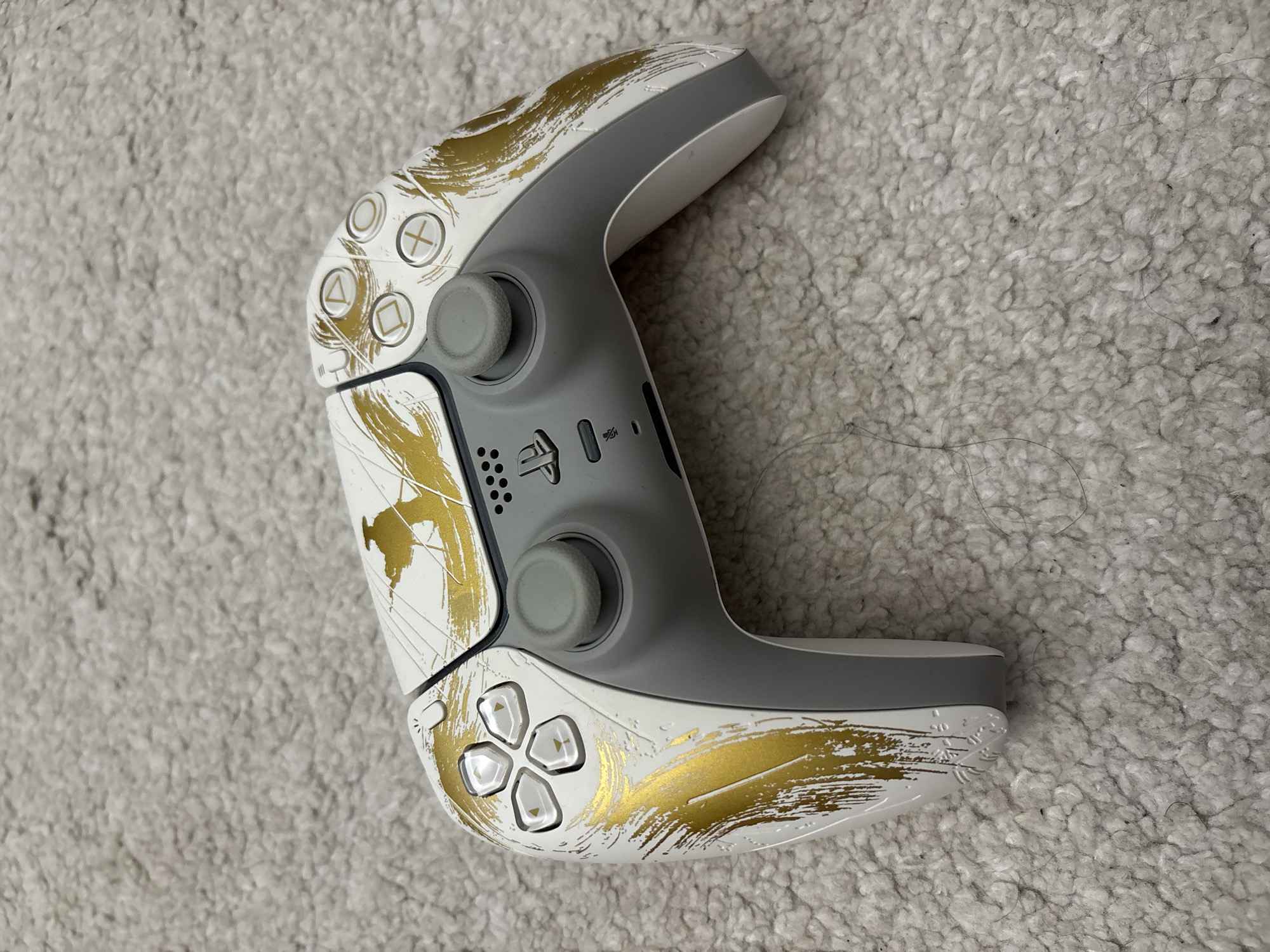 Decorated PlayStation 5 controller spotted on carpet