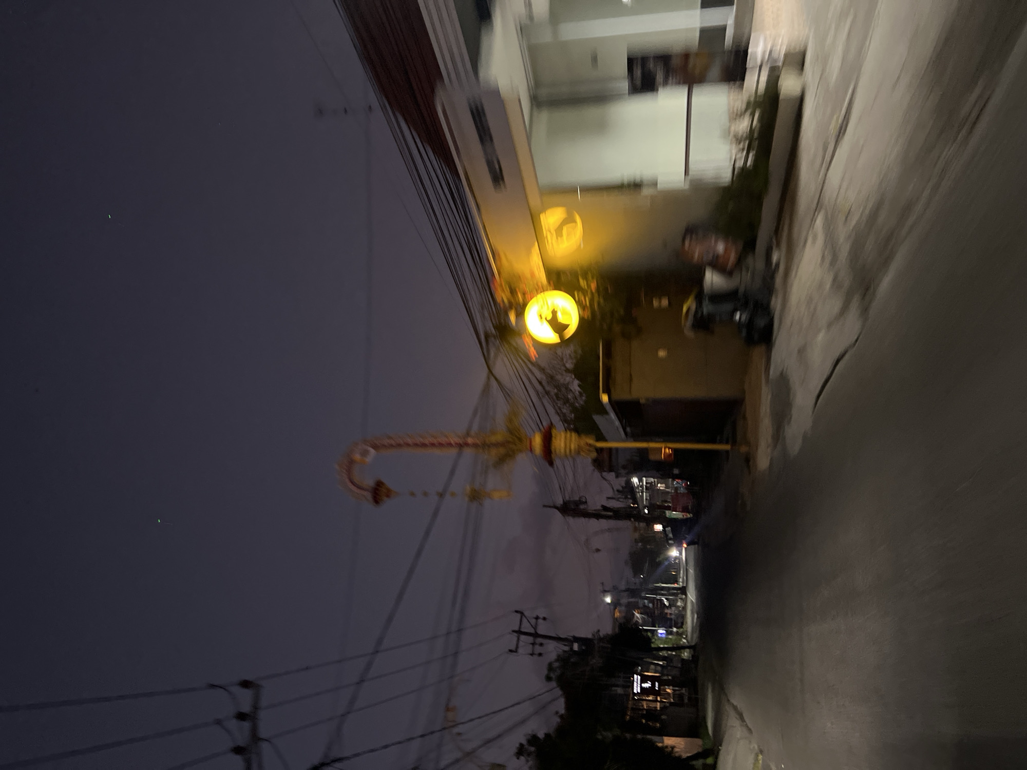 Dusk street scene in North Kuta with overhead power lines