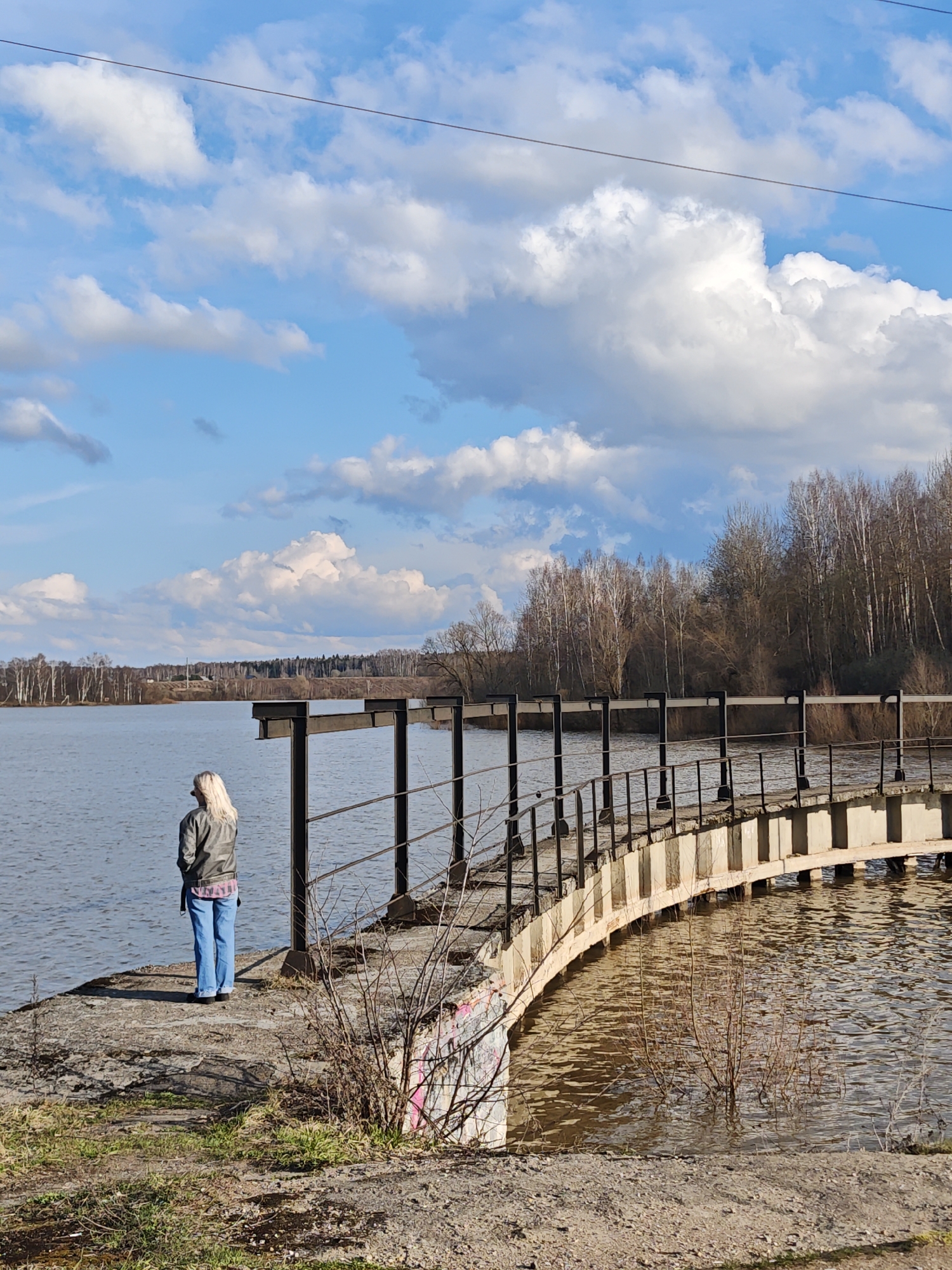 Woman photographed at water dam in Zhestylevo on sunny afternoon
