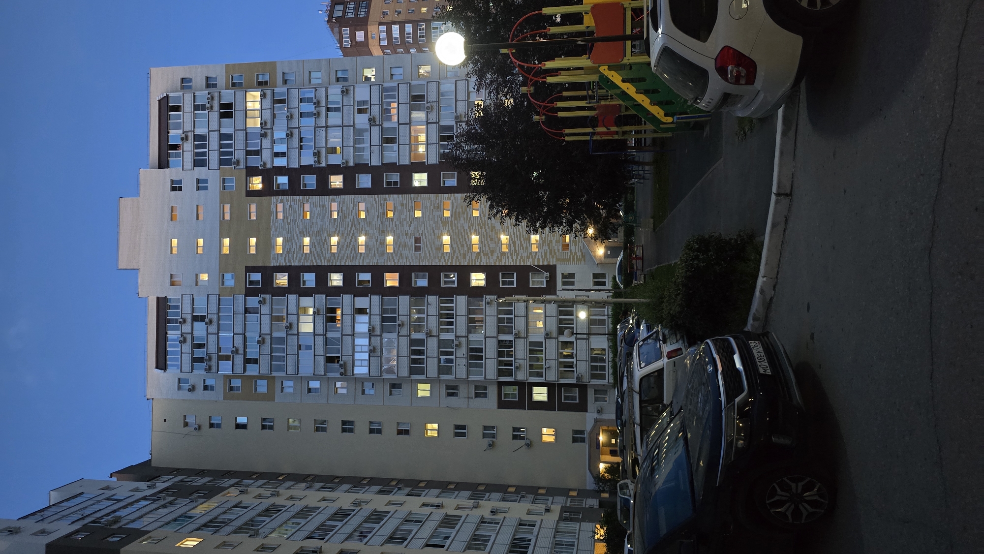 Tolyatti apartment blocks at dusk, one sitting waterside