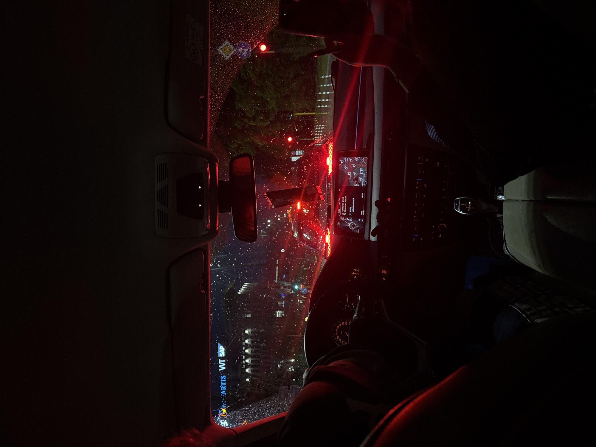 Rainy evening cityscape viewed from car interior in Sofia