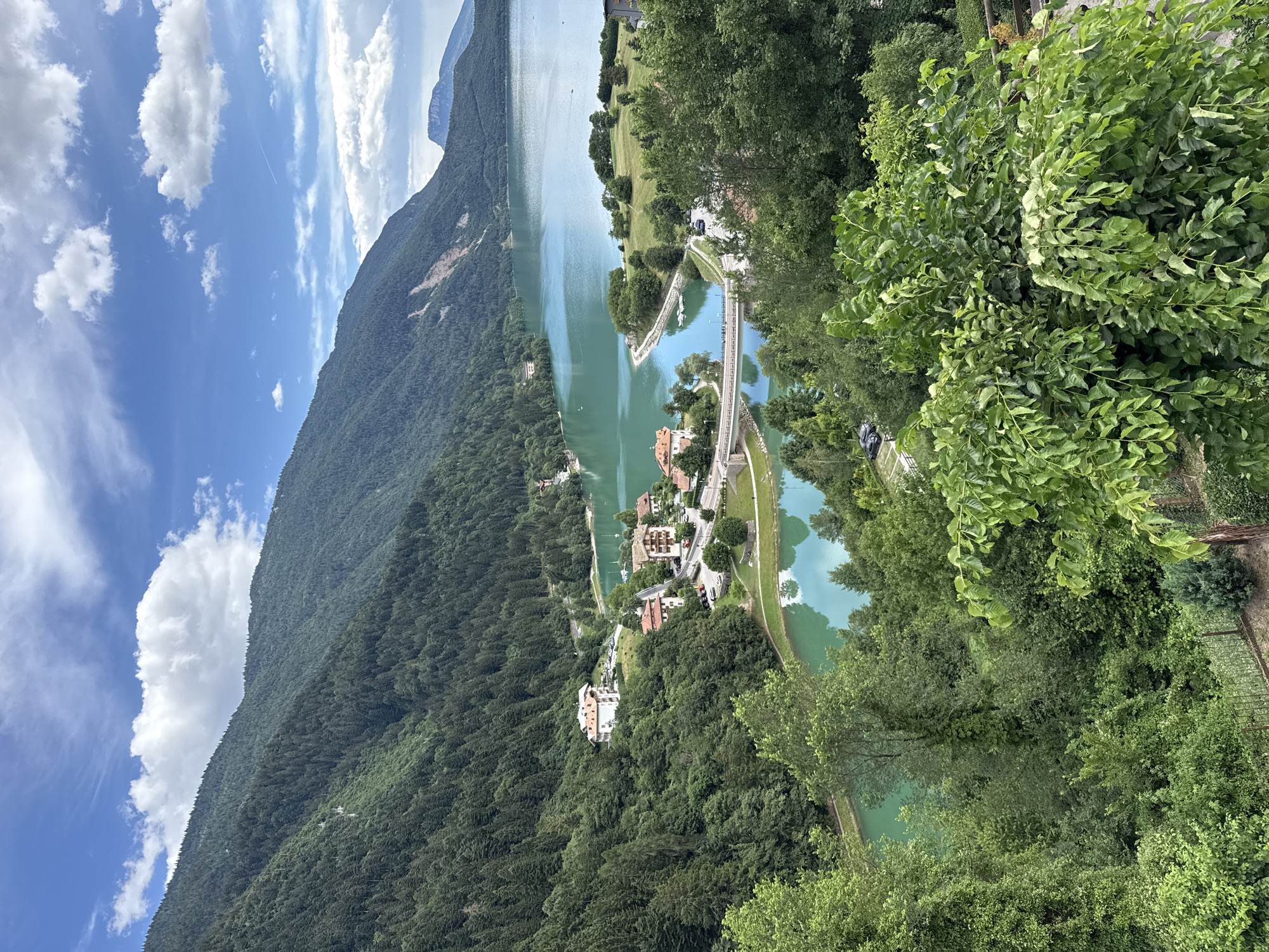 Paragliding over Molveno's turquoise lake and Alpine peaks