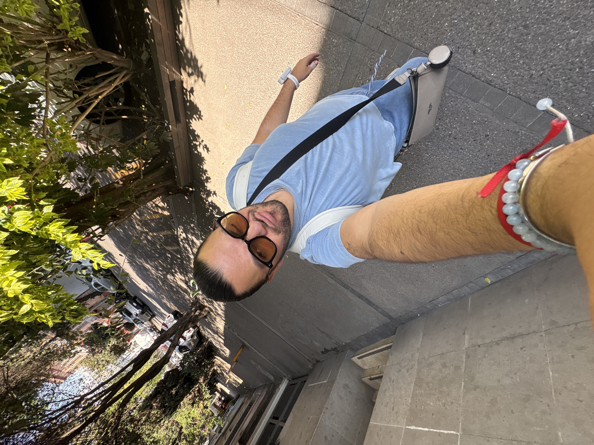 Person documents sunny afternoon walk through Mexico City streets