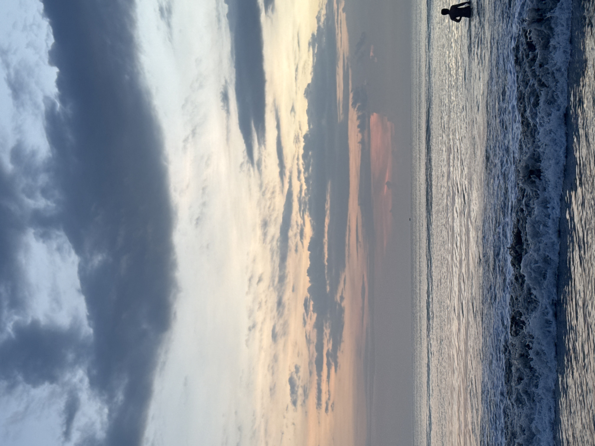Swimmers enjoy sunset waters at Kuta Selatan beach