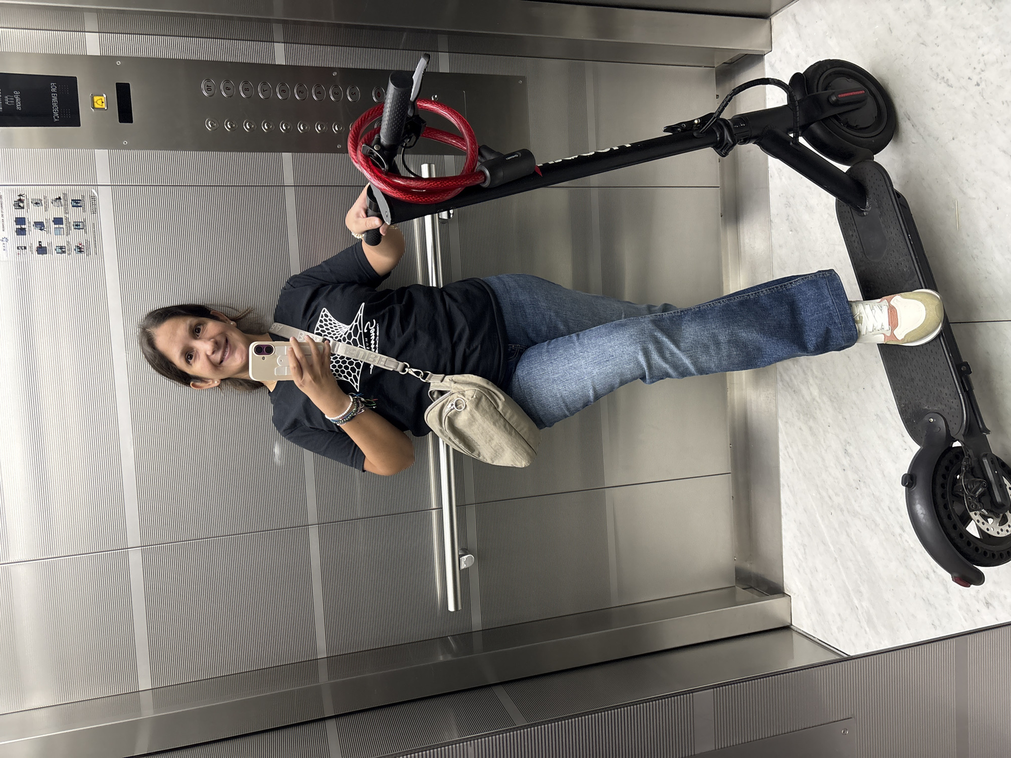 Woman takes smiling elevator selfie in San Isidro
