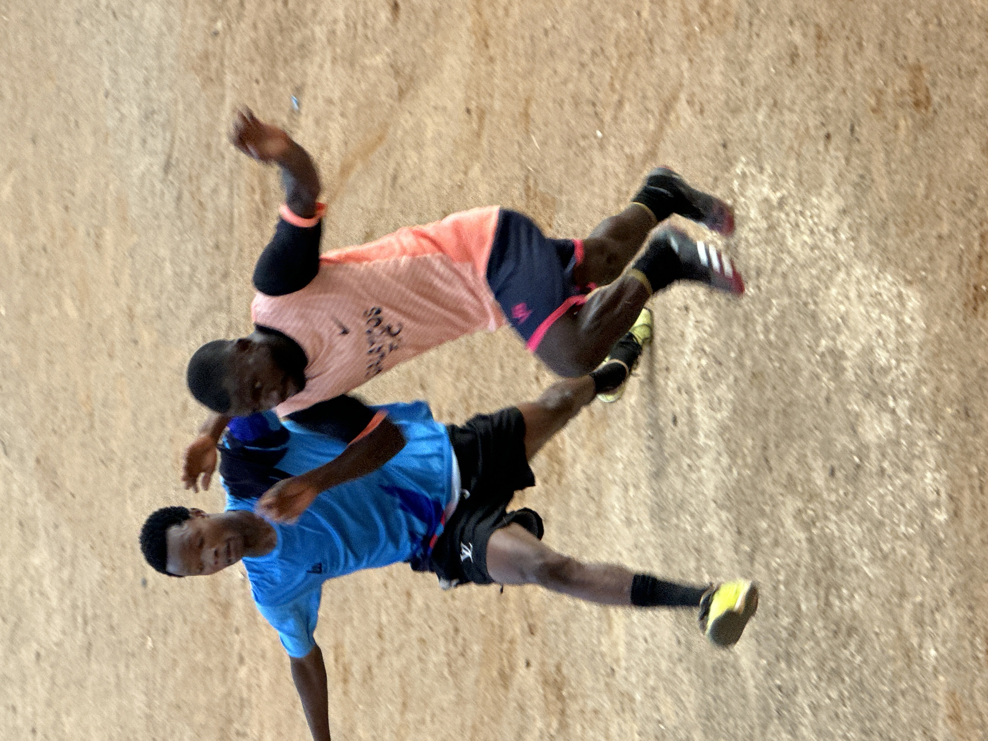 Pickup soccer on a rocky dirt field in Jos, Nigeria