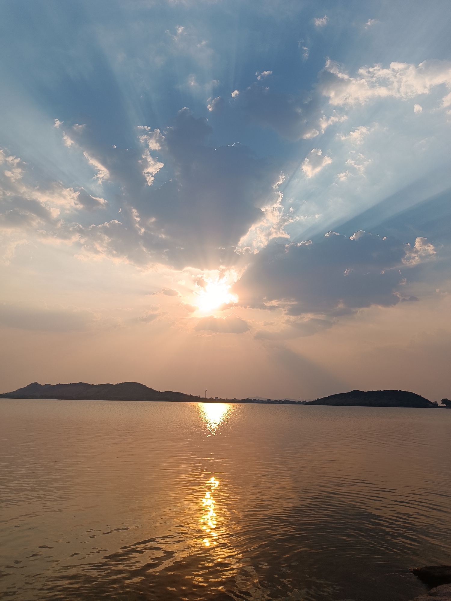 Witness captures sunlit water vista with distant hills