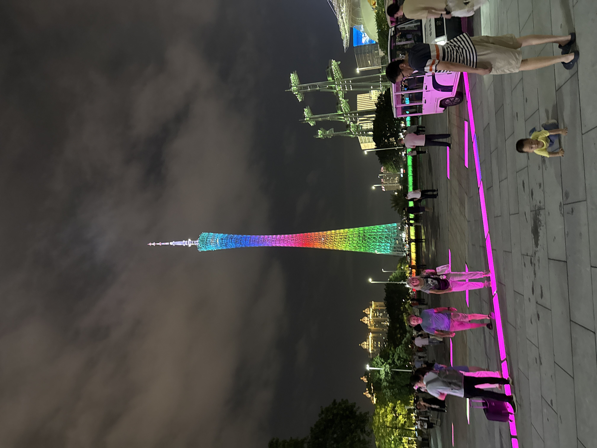 Canton Tower lights up a crowded Guangzhou plaza at night