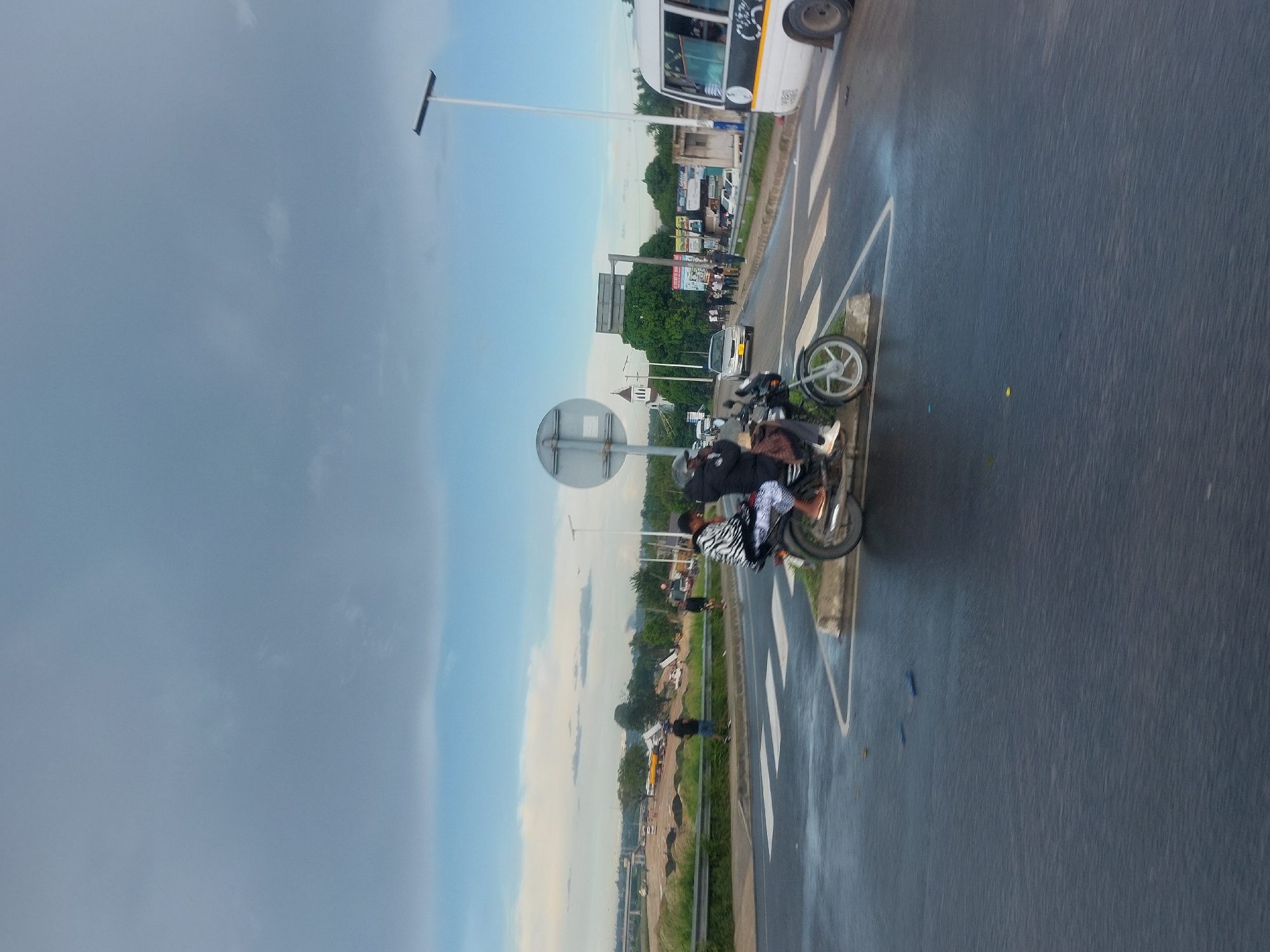 Motorcycle traffic observed on wet Dar es-Salaam street