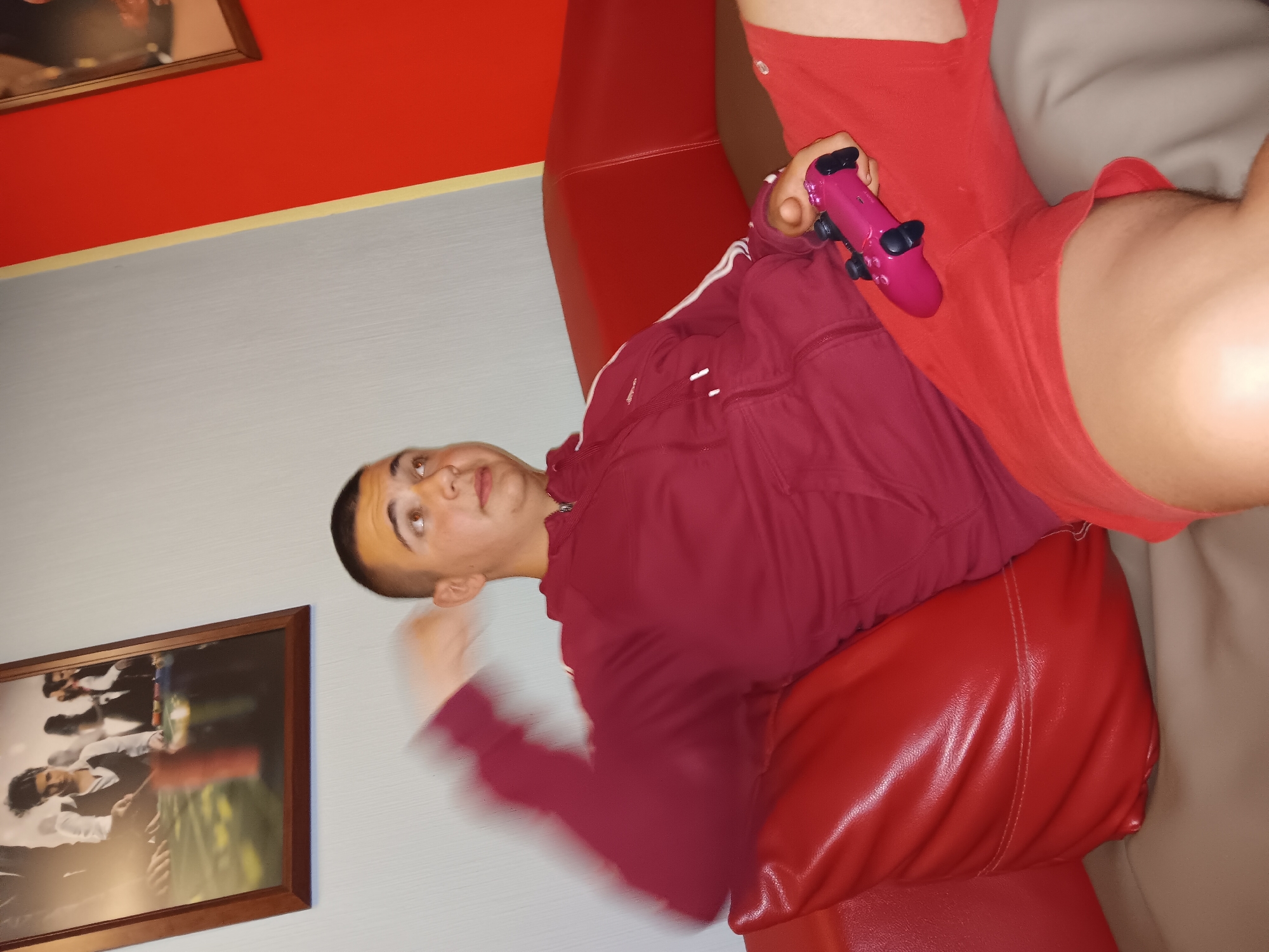 People in red clothing gather indoors during evening hours