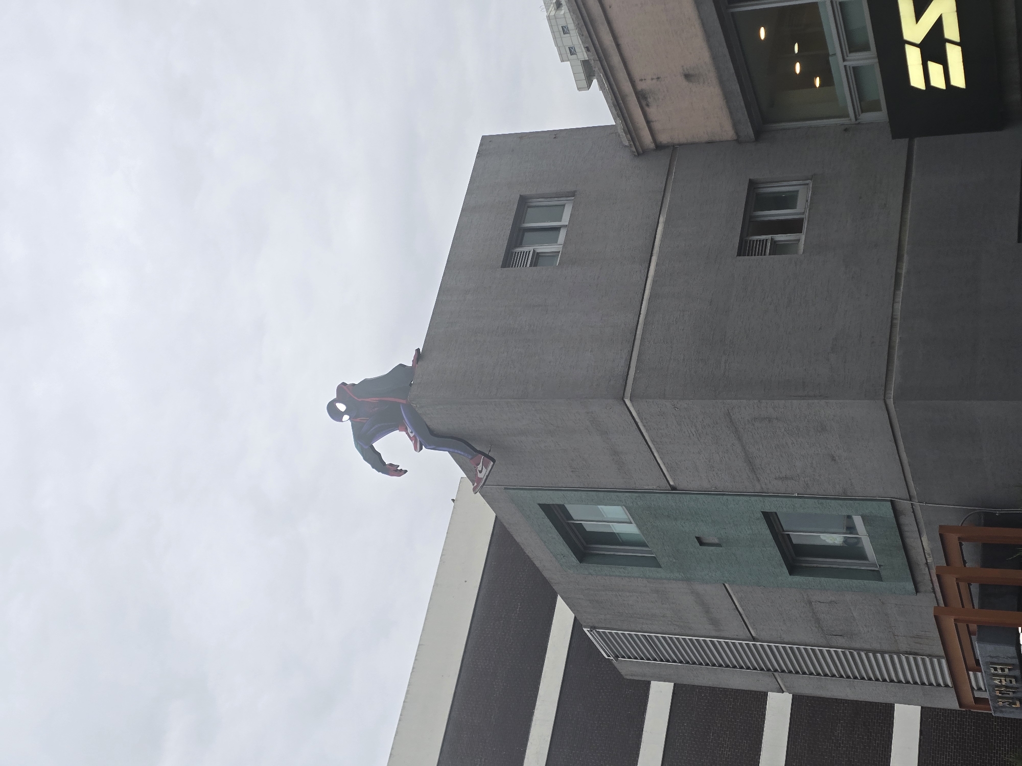Spider-Man costumed person spotted clinging to building in Daegu