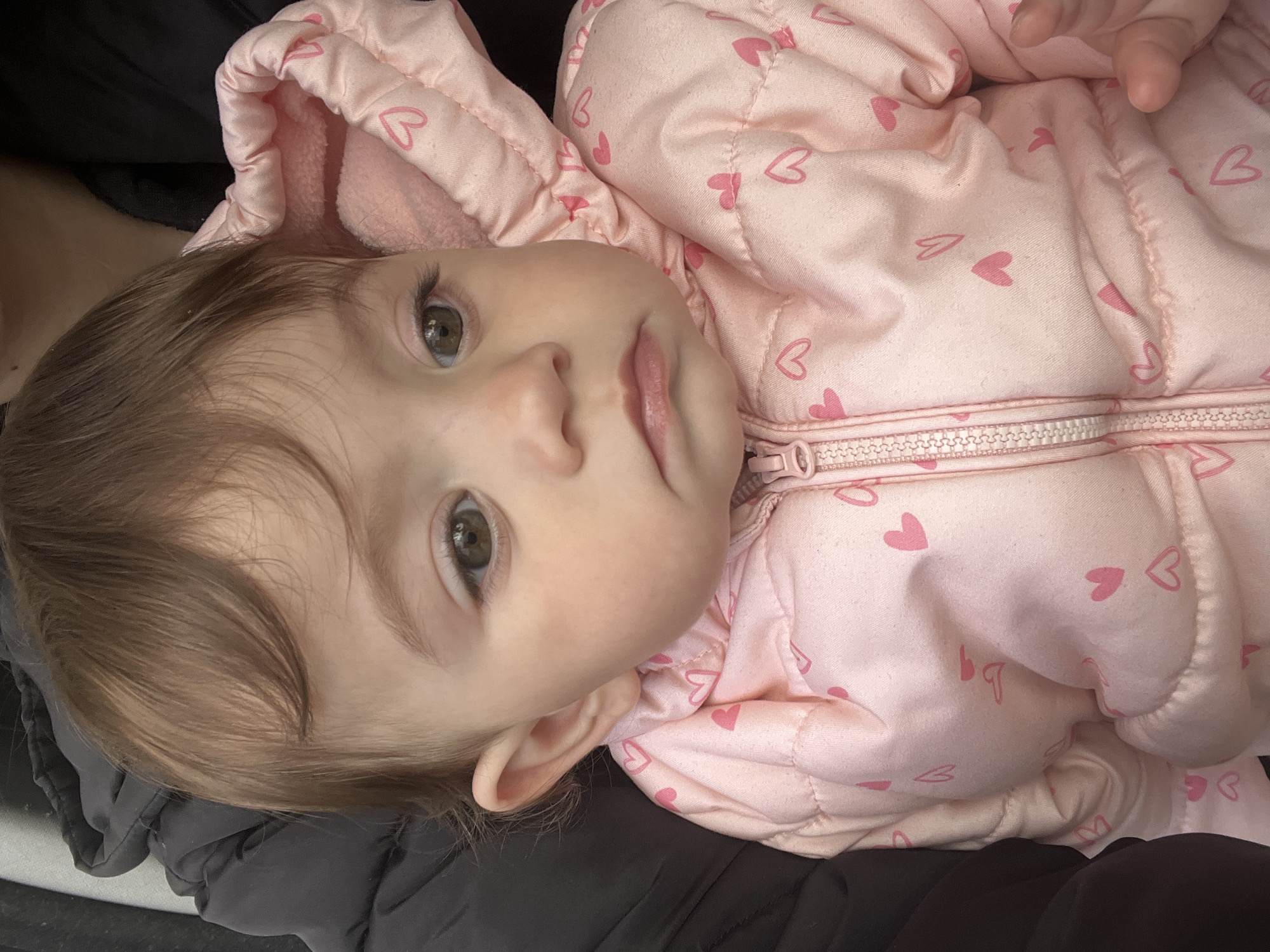 Baby in pink heart jacket photographed in Elena, Bulgaria