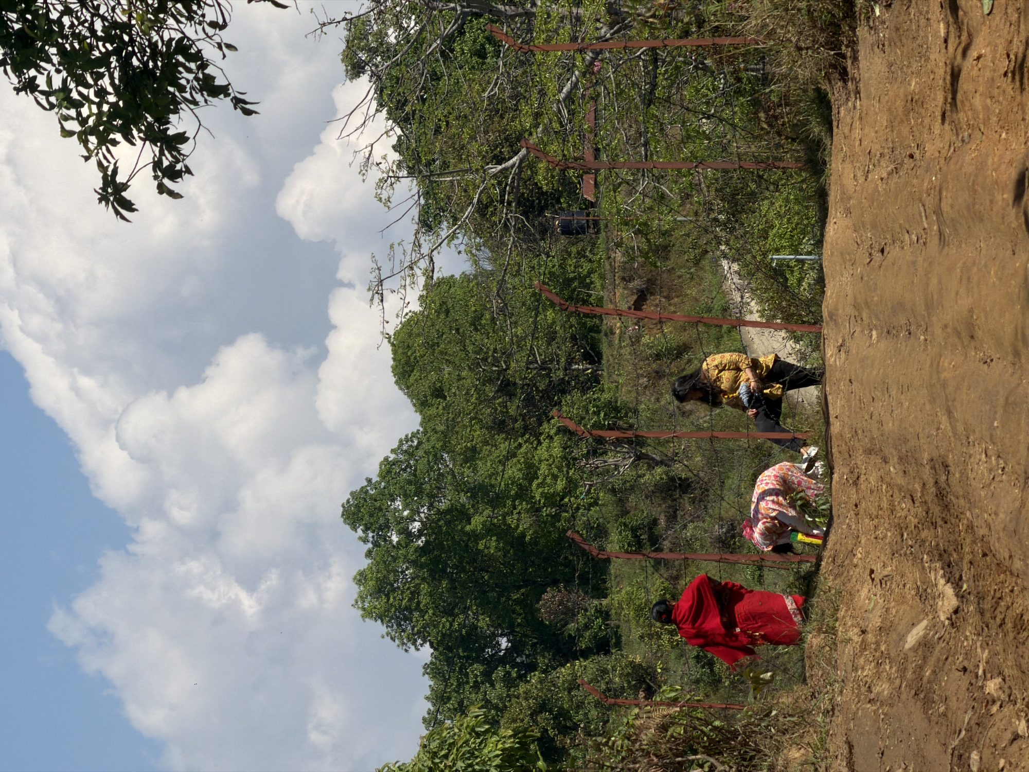 Three people spotted on grassy slope near Pokhara