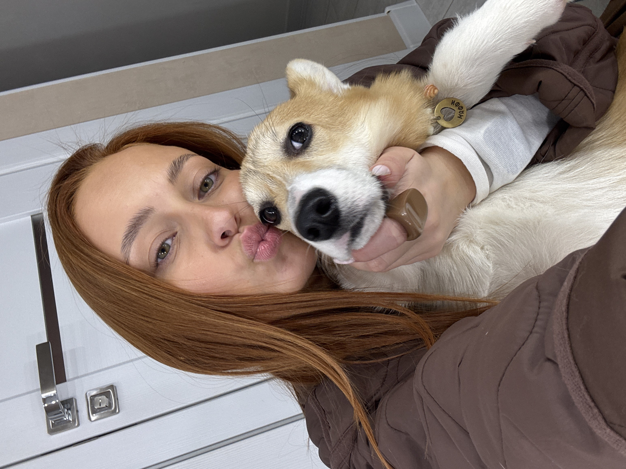 Woman takes selfie with small dog in Chaikovsky, Russia