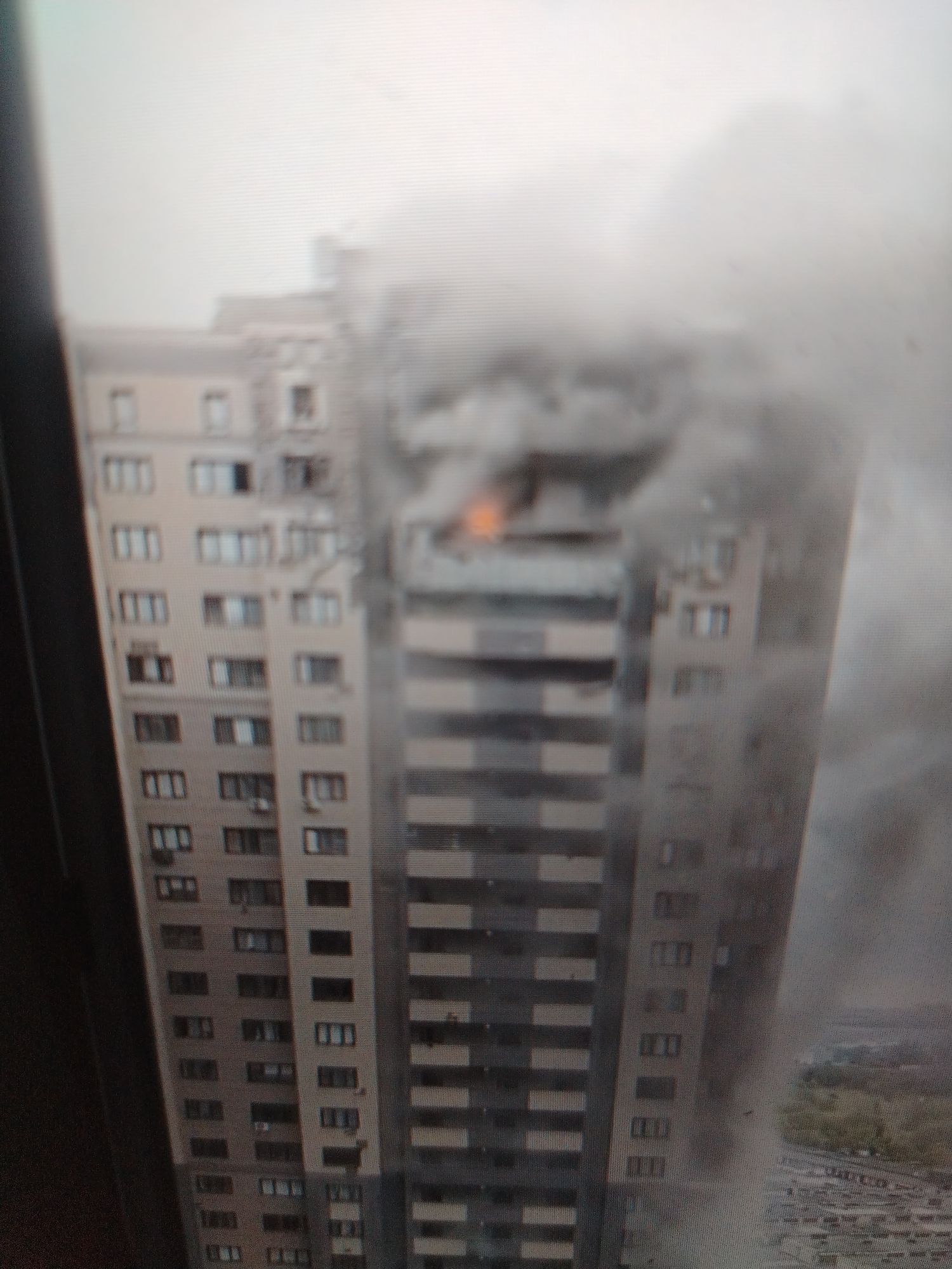 Major fire engulfs high-rise and industrial structures amid heavy smoke