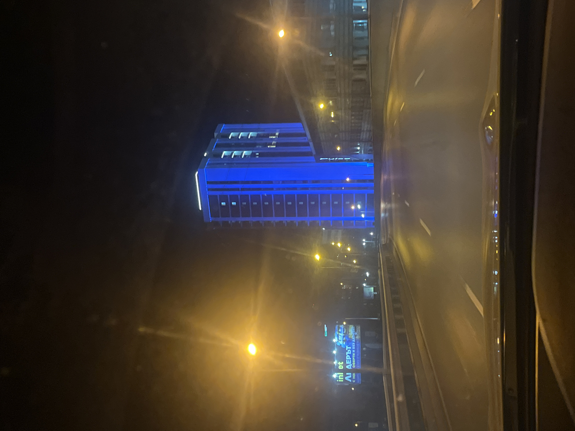 Nighttime drive through illuminated Sofia streets captured on video