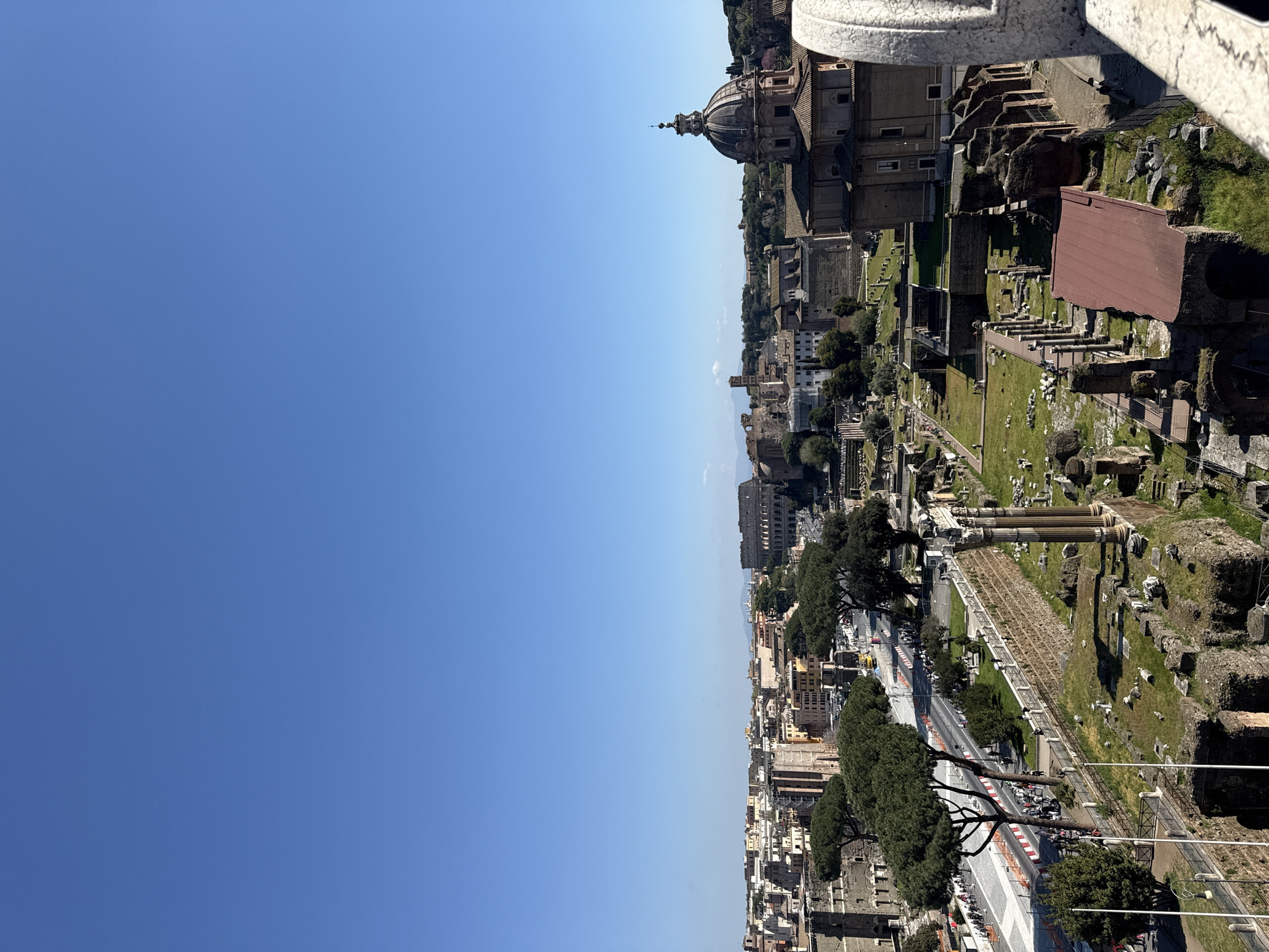 Tourist captures Rome landmarks from elevated restaurant terrace