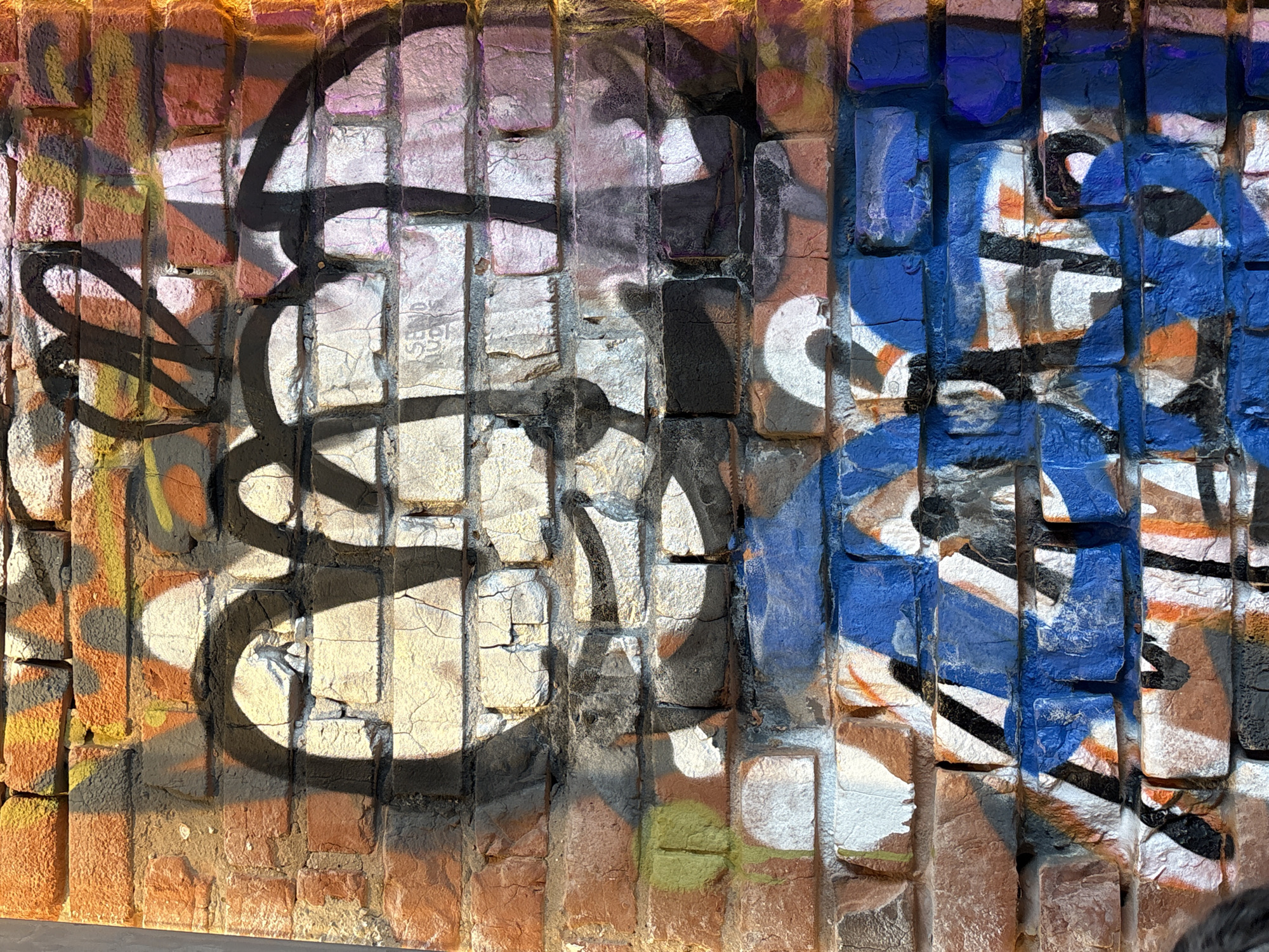Graffiti spotted on textured brick wall in Kazan