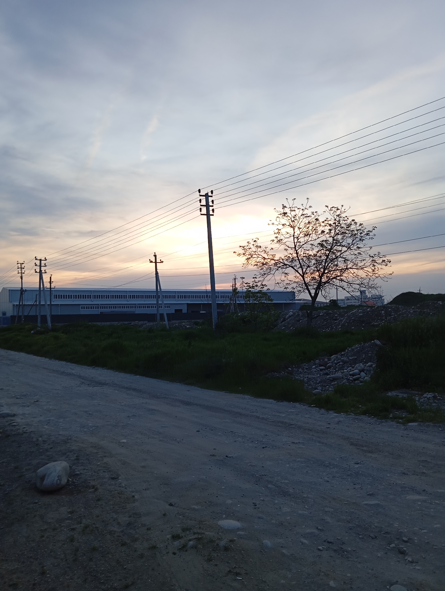 Dusk landscape with curved dirt road documented in Baksan