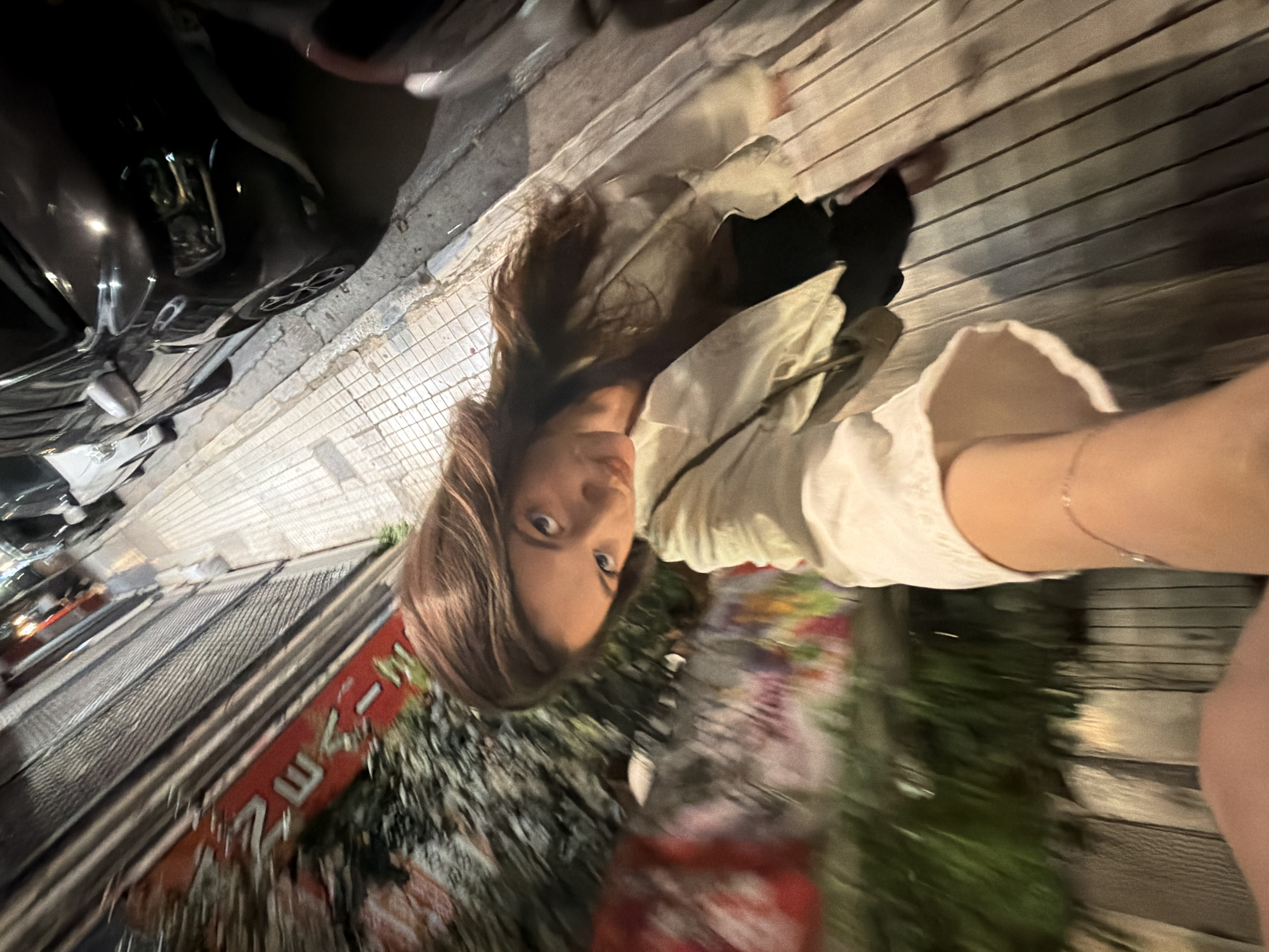 Woman takes selfies on Athens street at night